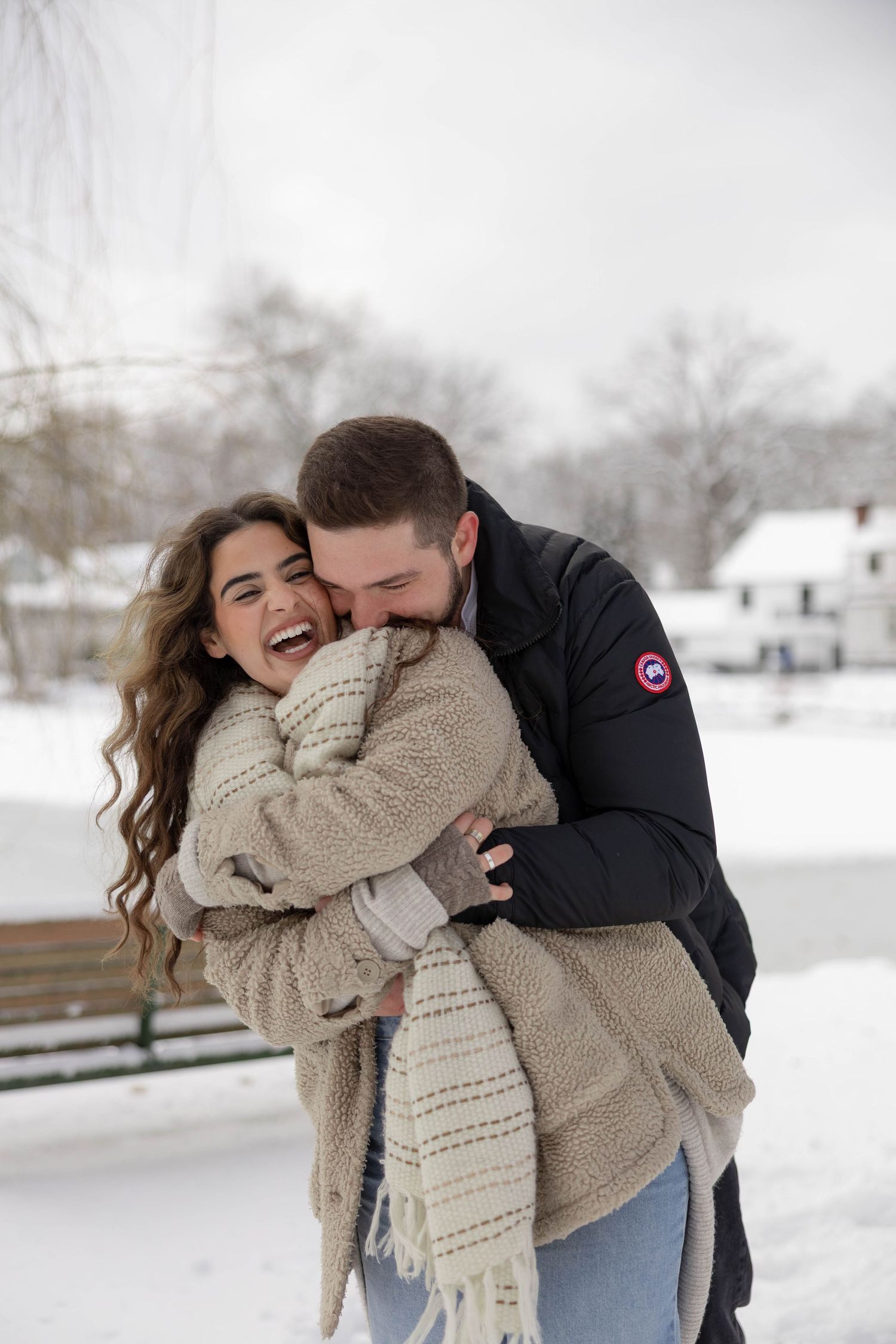 Engaged couple embrace each other in a snowy, winter photo shoot in New Jersey