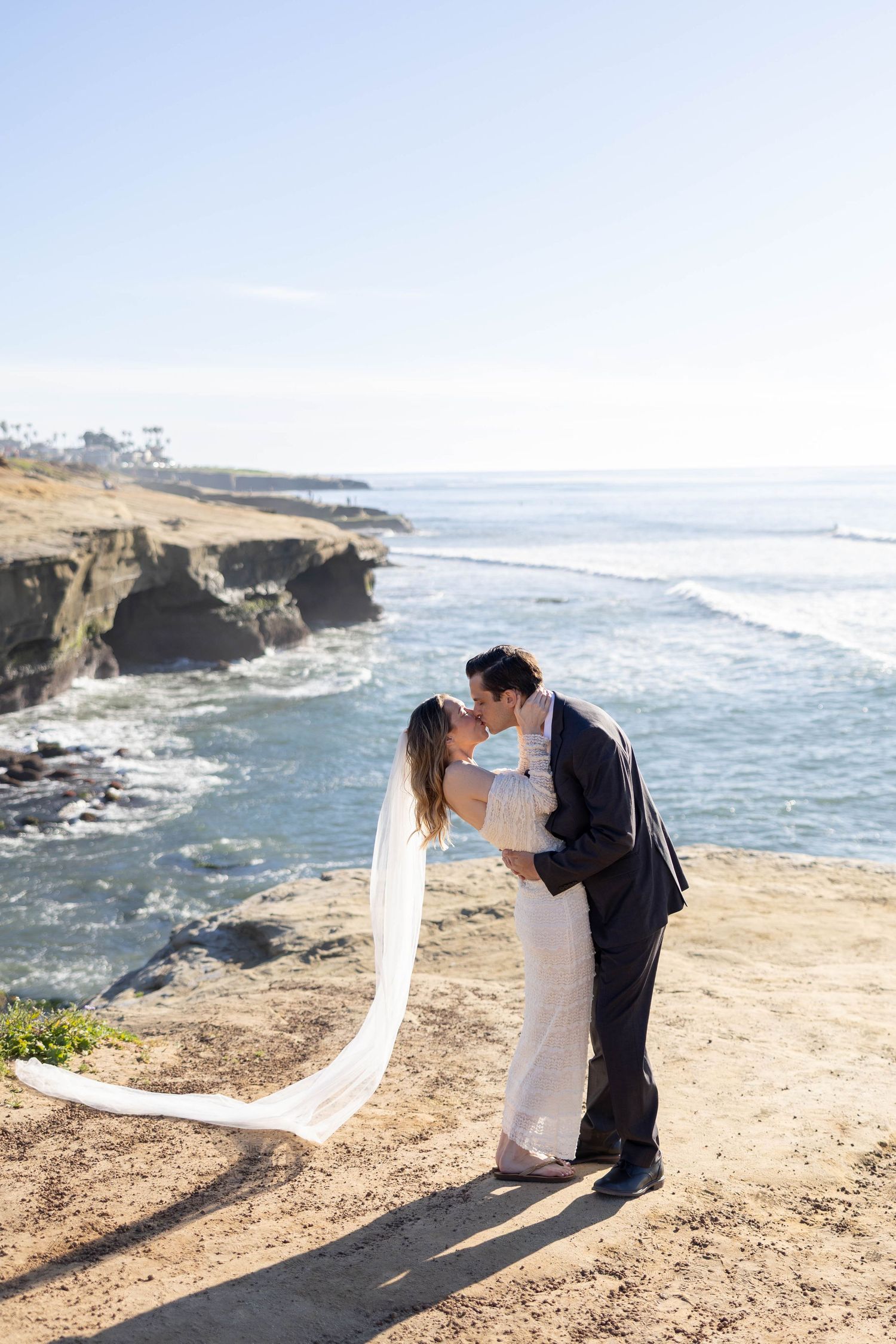 Bride and groom go in for a kiss at their elopement in San Diego.