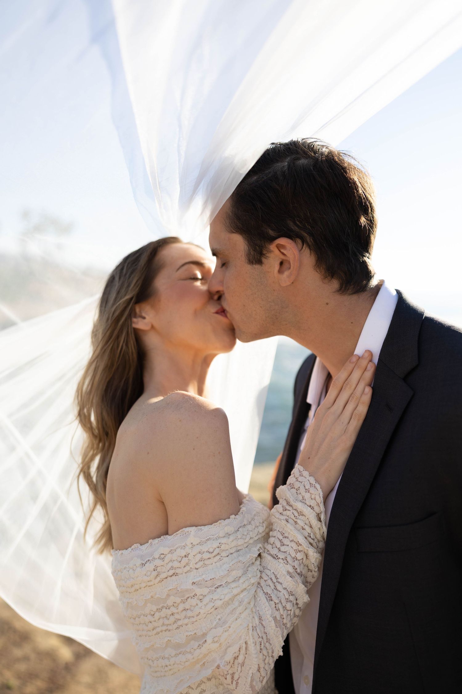 Bride and groom go in for a kiss on their wedding day in San Diego, California