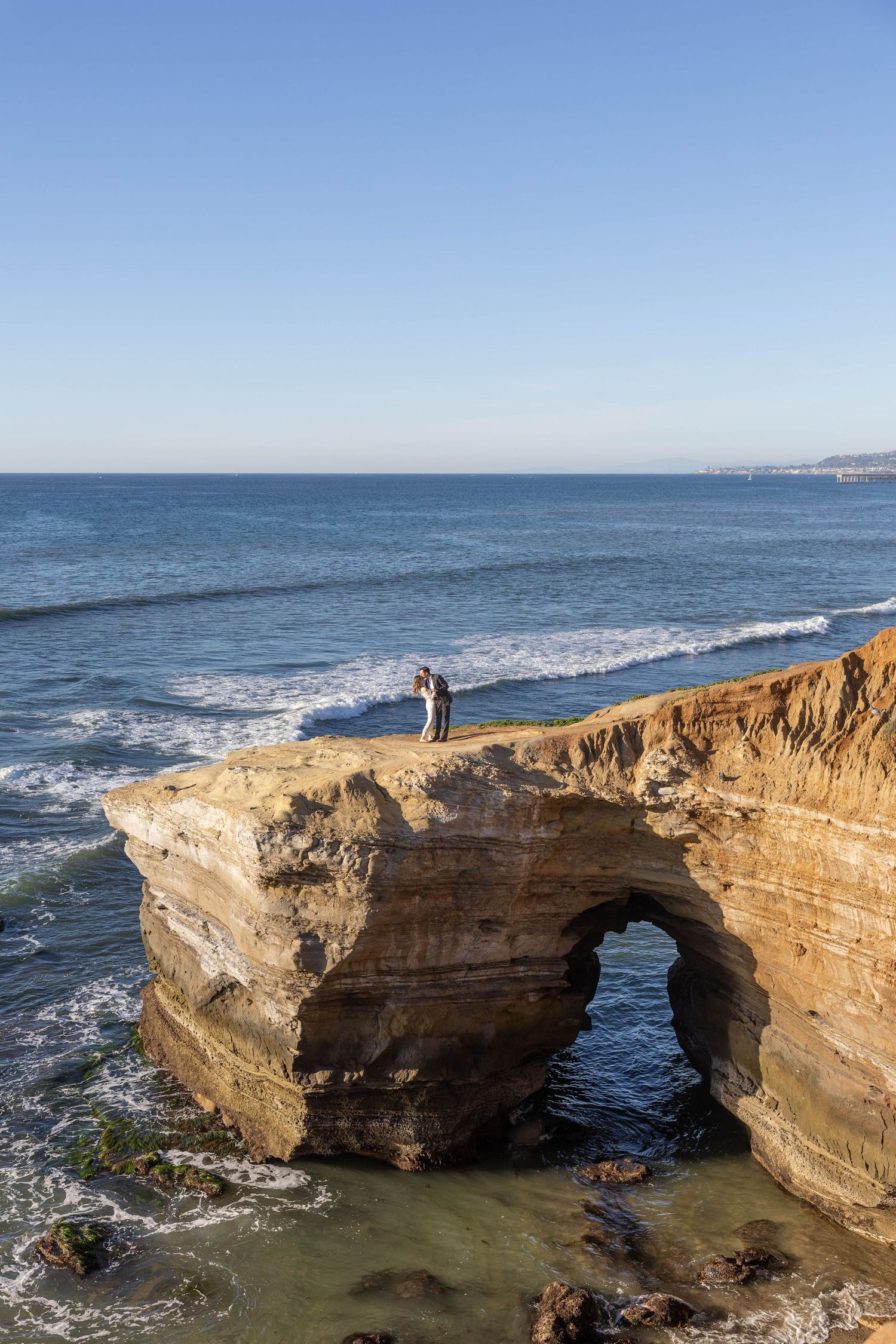 Bride and groom have a moment alone during their coastal elopement at Sunset Cliffs.