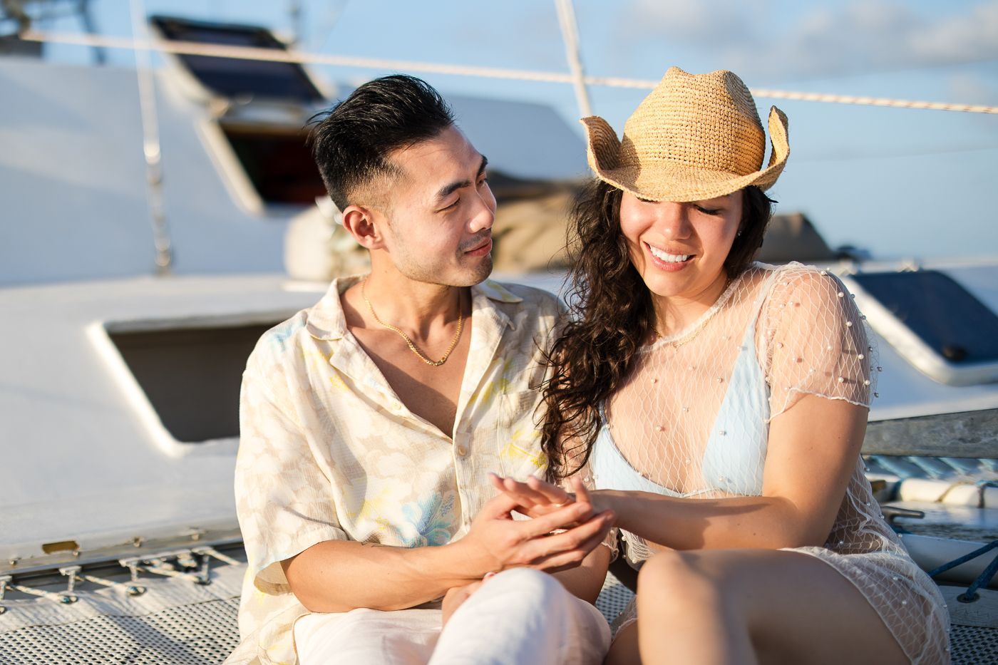 Tobago wedding photographers Celeste and Reece documenting the couple’s engagement on a catamaran cruise at sunset