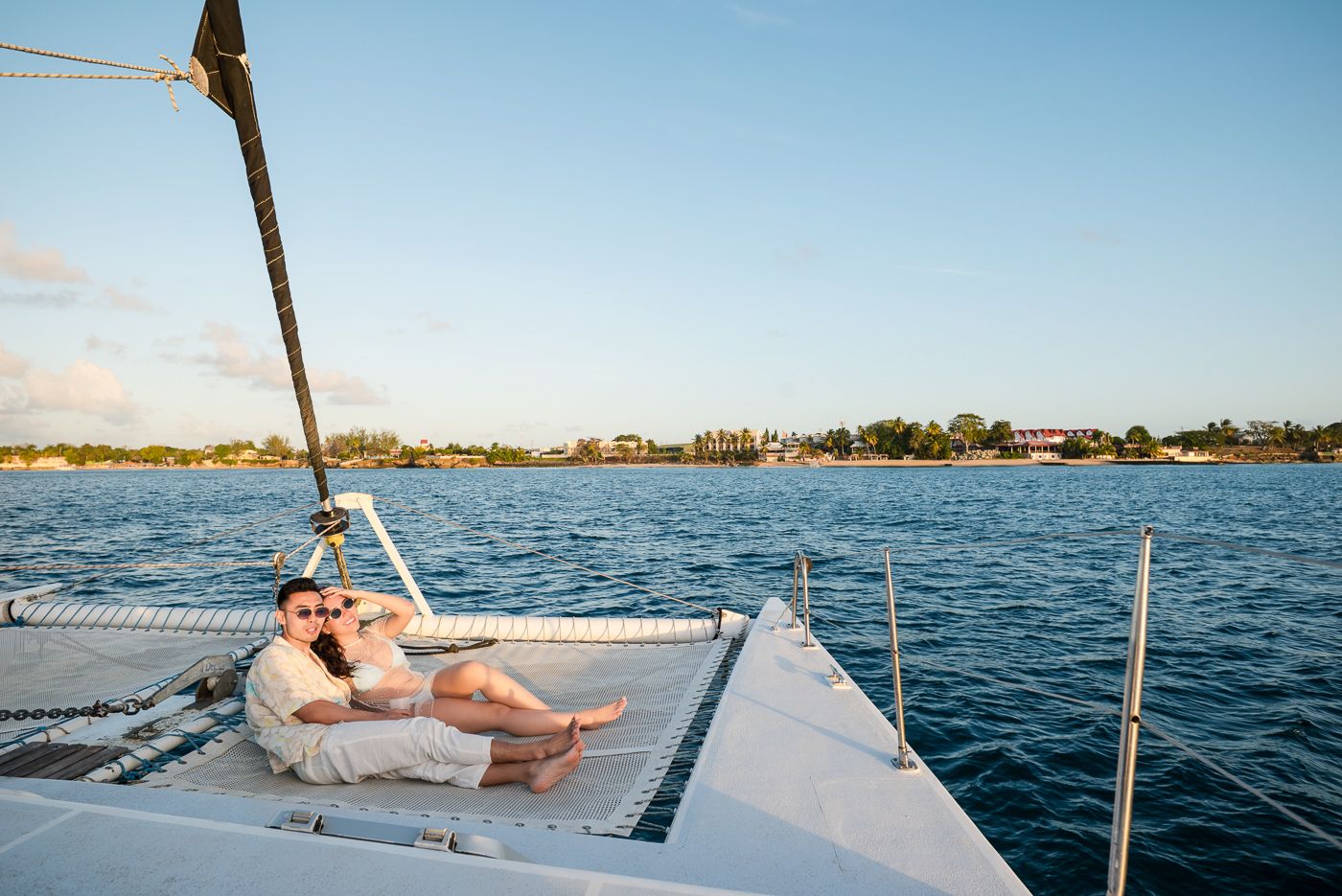 Caribbean wedding photographers Celeste & Reece documenting the couple’s champagne toast on a catamaran