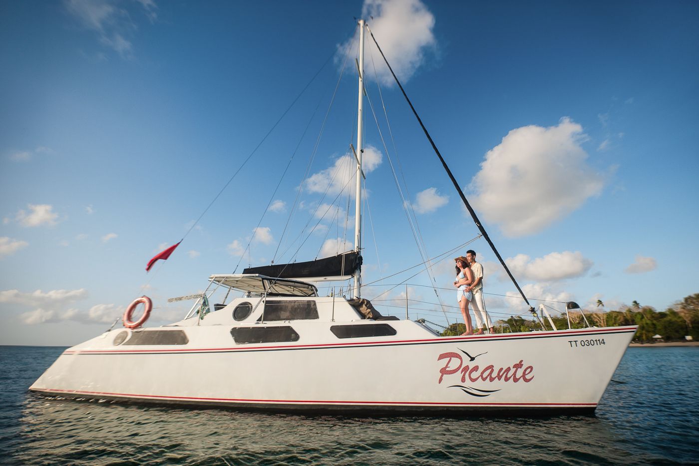 Caribbean wedding photographers Celeste & Reece documenting the couple on a catamaran in the Caribbean Sea