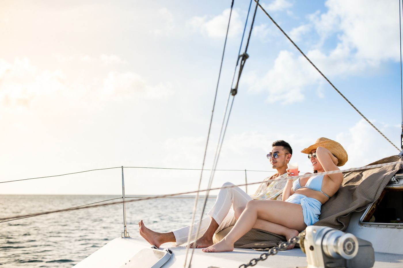Caribbean wedding photographers Celeste & Reece documenting the couple’s champagne toast on a catamaran