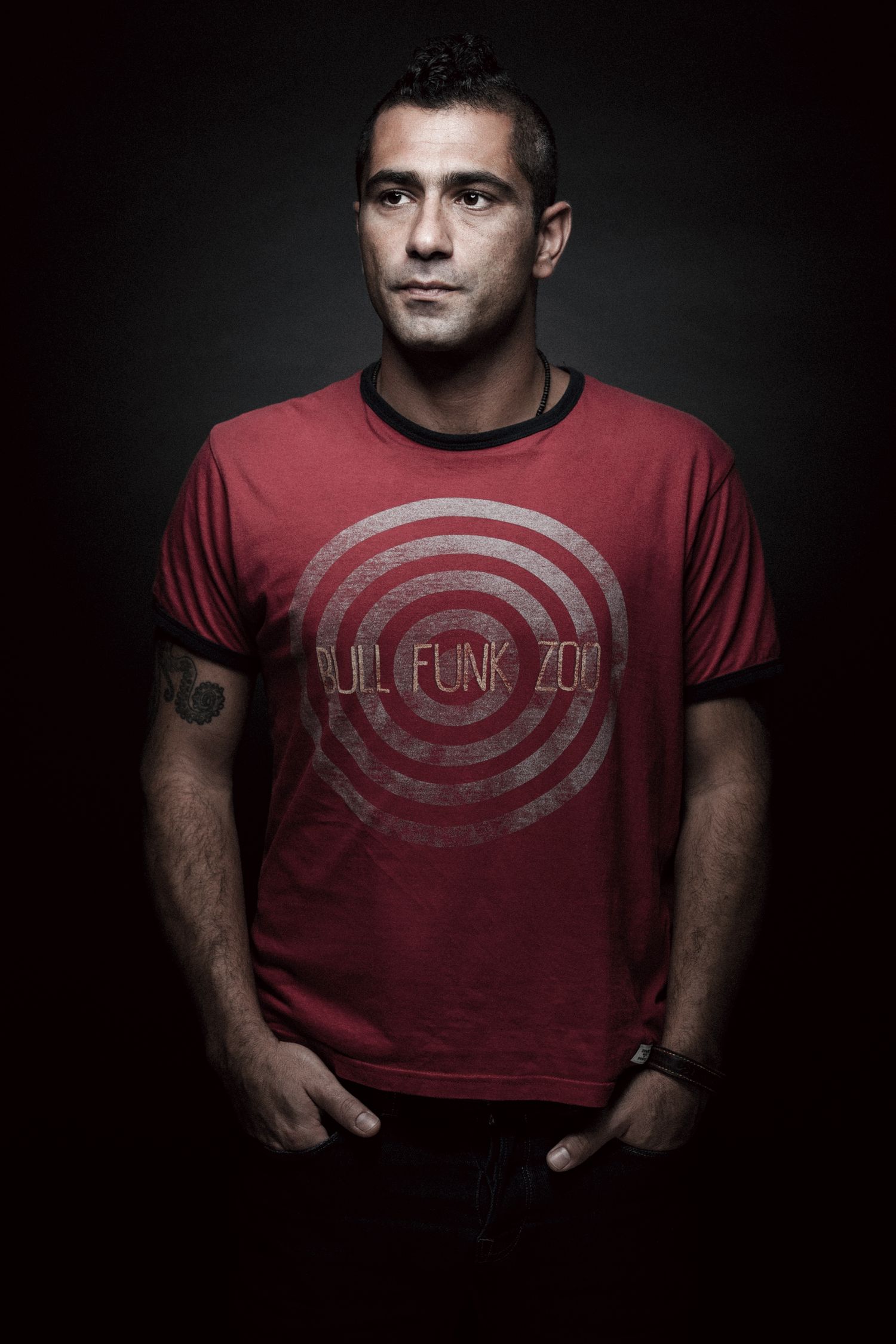 Dramatic studio portrait series showing person in red t-shirt against dark background. portrait photographer in guelph and surrounding areas