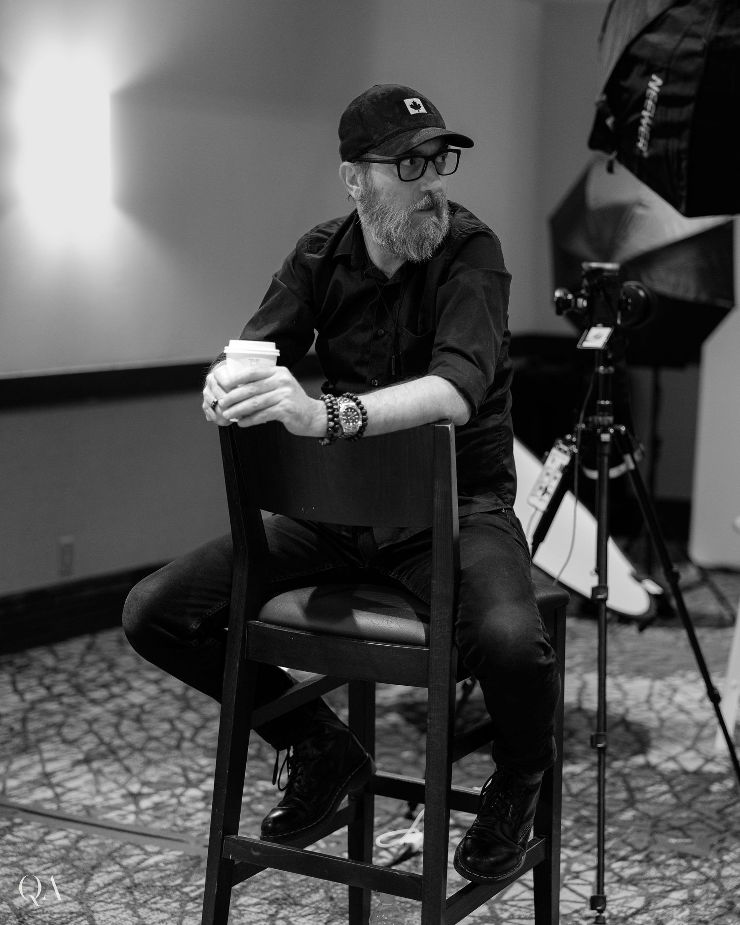 Black and white photo series of someone sitting in chairs during an interview session.