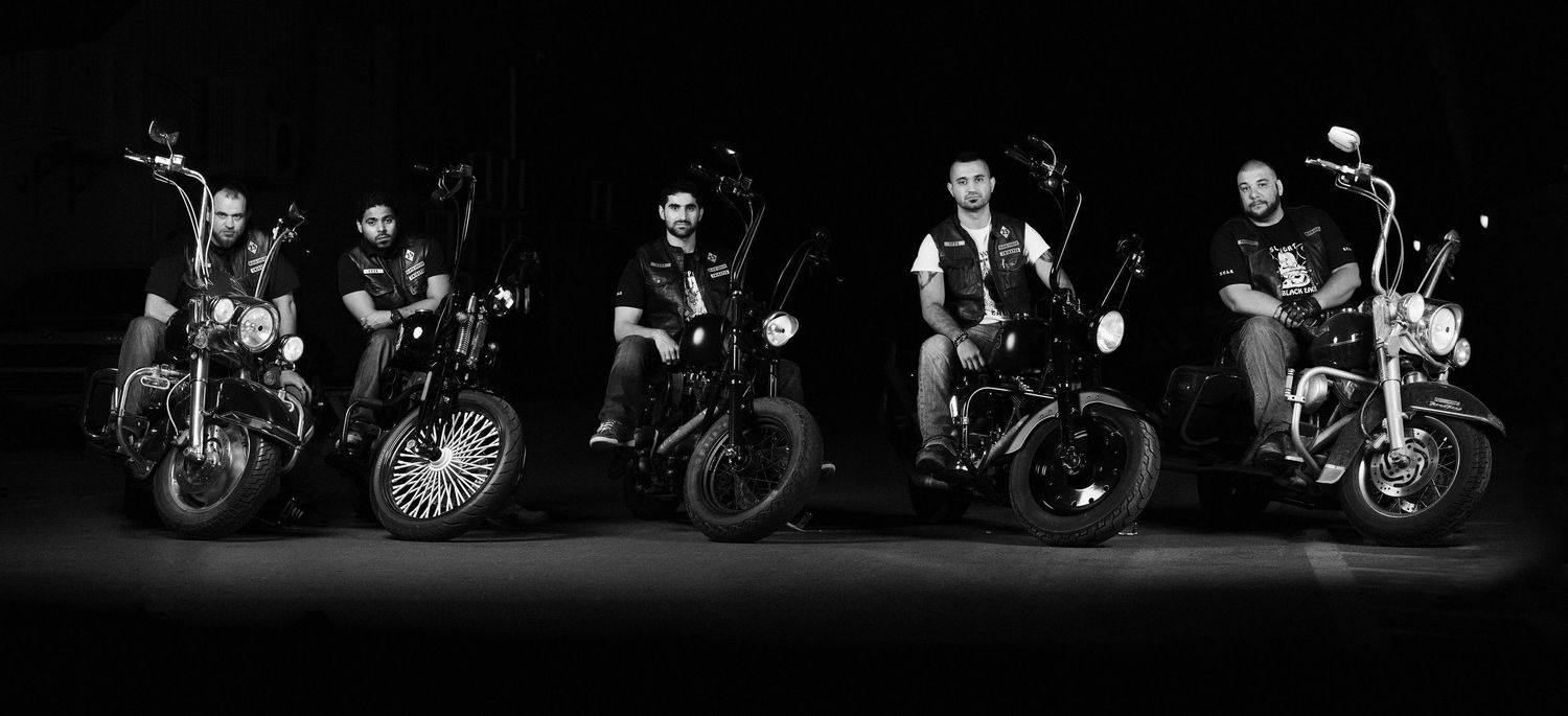 Silhouetted motorcycles lined up in a dark dramatic composition. Portrait Photographer in Ontario