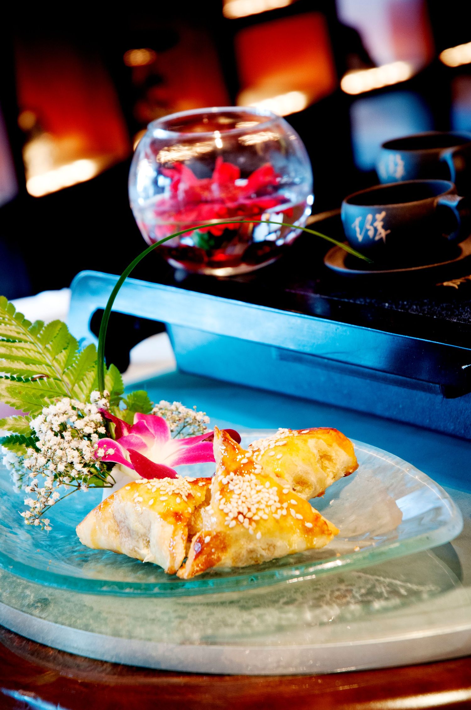 Elegantly plated sushi rolls served on glass plates in a restaurant setting. Commercial and food photographer in guelph ontario
