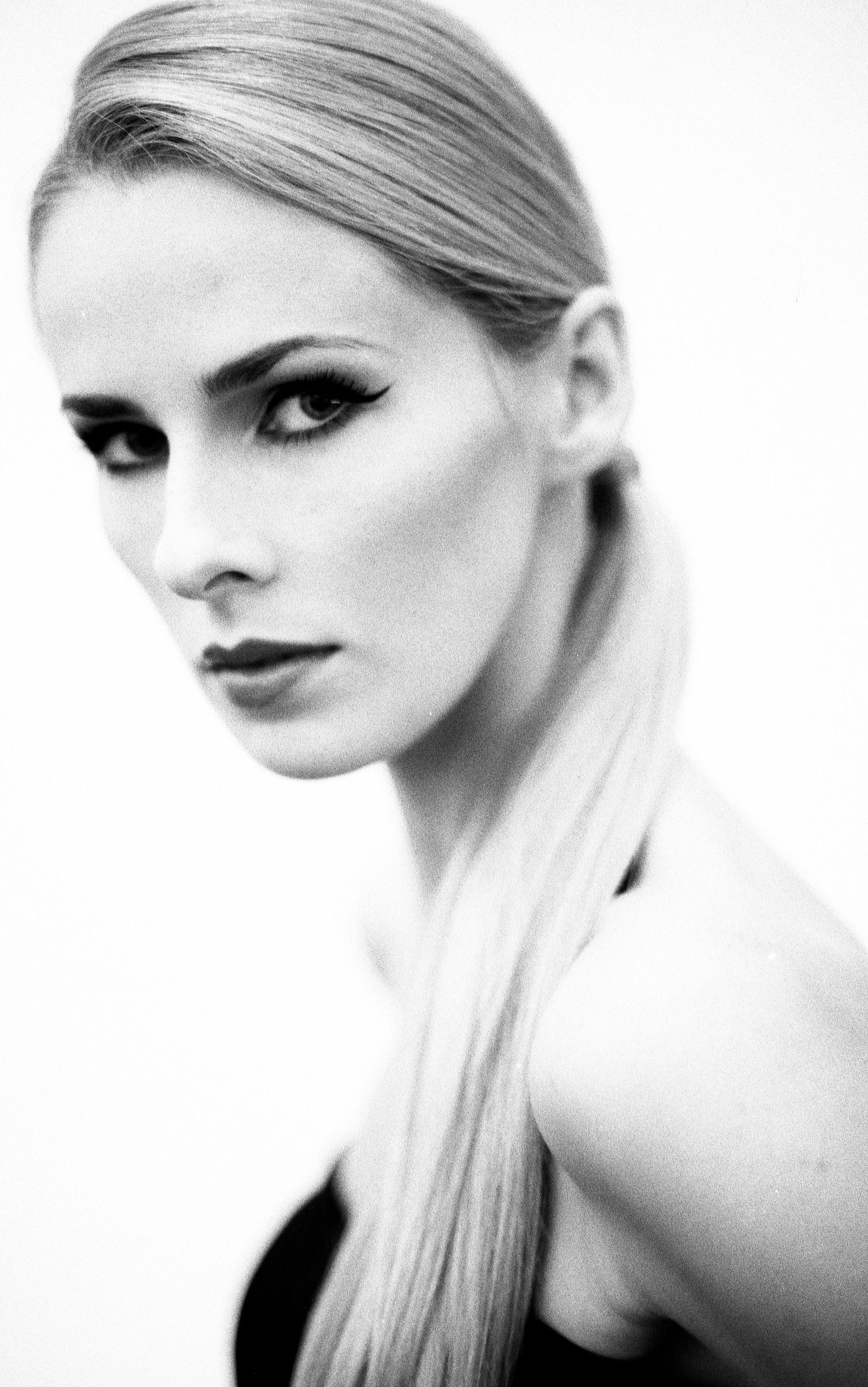 High-key beauty portraits with dramatic makeup and striking poses on white background. Portrait Photographer in Ontario
