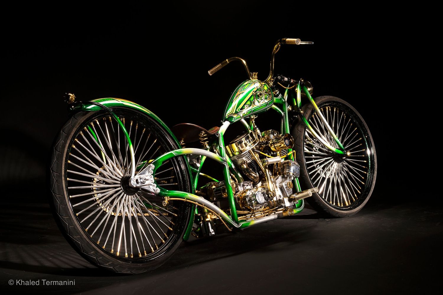 Custom green motorcycle photographed in dramatic low-key lighting against black background. .Portrait Photographer in Guelph Ontario