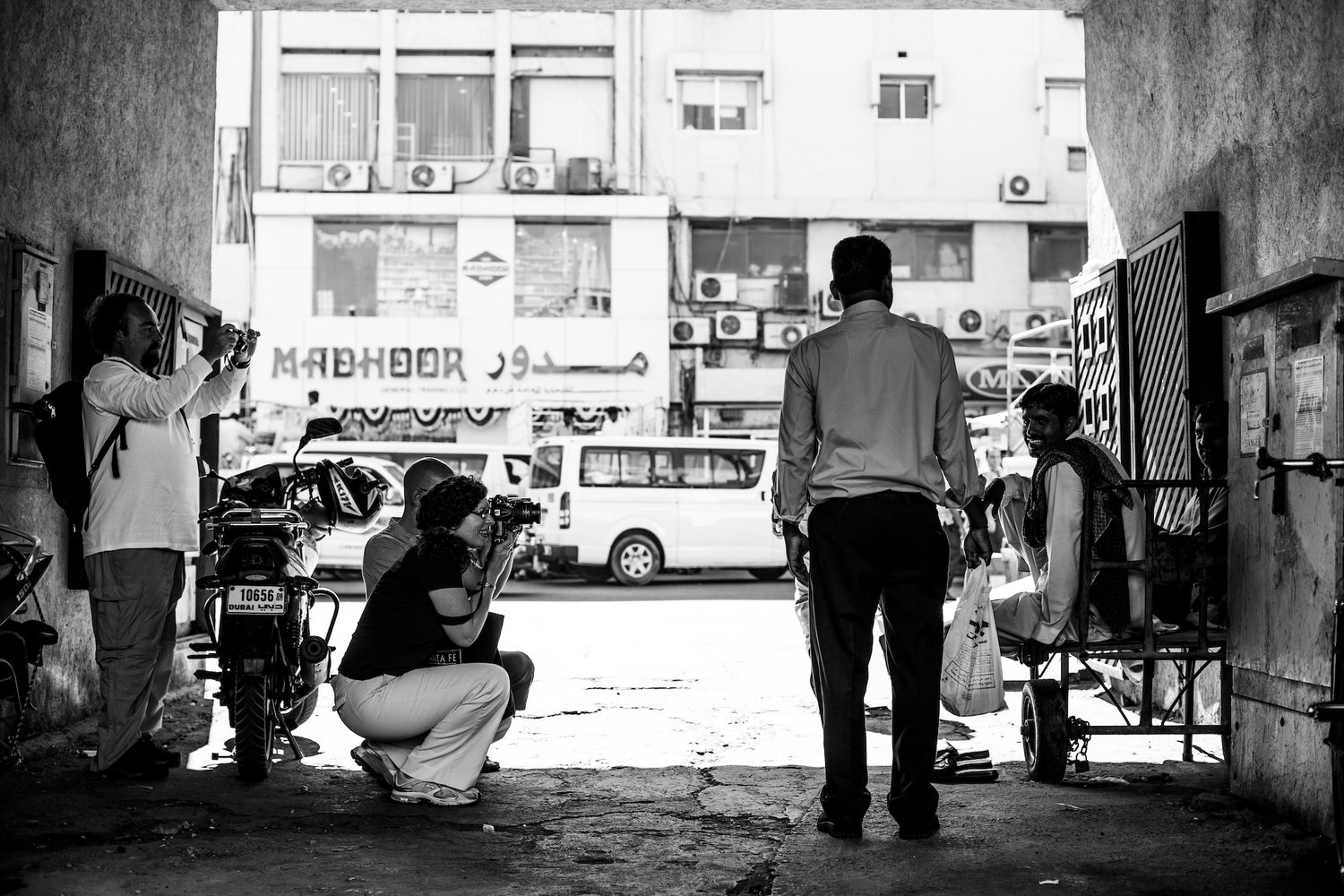 Black and white urban street scene with silhouettes of people and buildings. photography workshops in guelph and surrounding areas