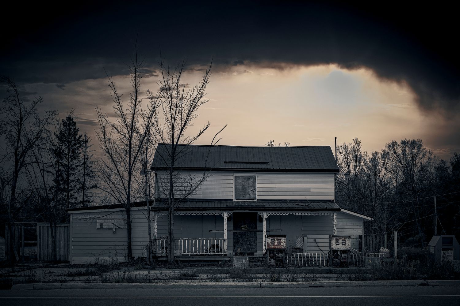 A series of dark, moody landscape shots featuring silhouettes of rural barns and farm buildings at dusk. Acton Gas Station.  Ontario, Canada