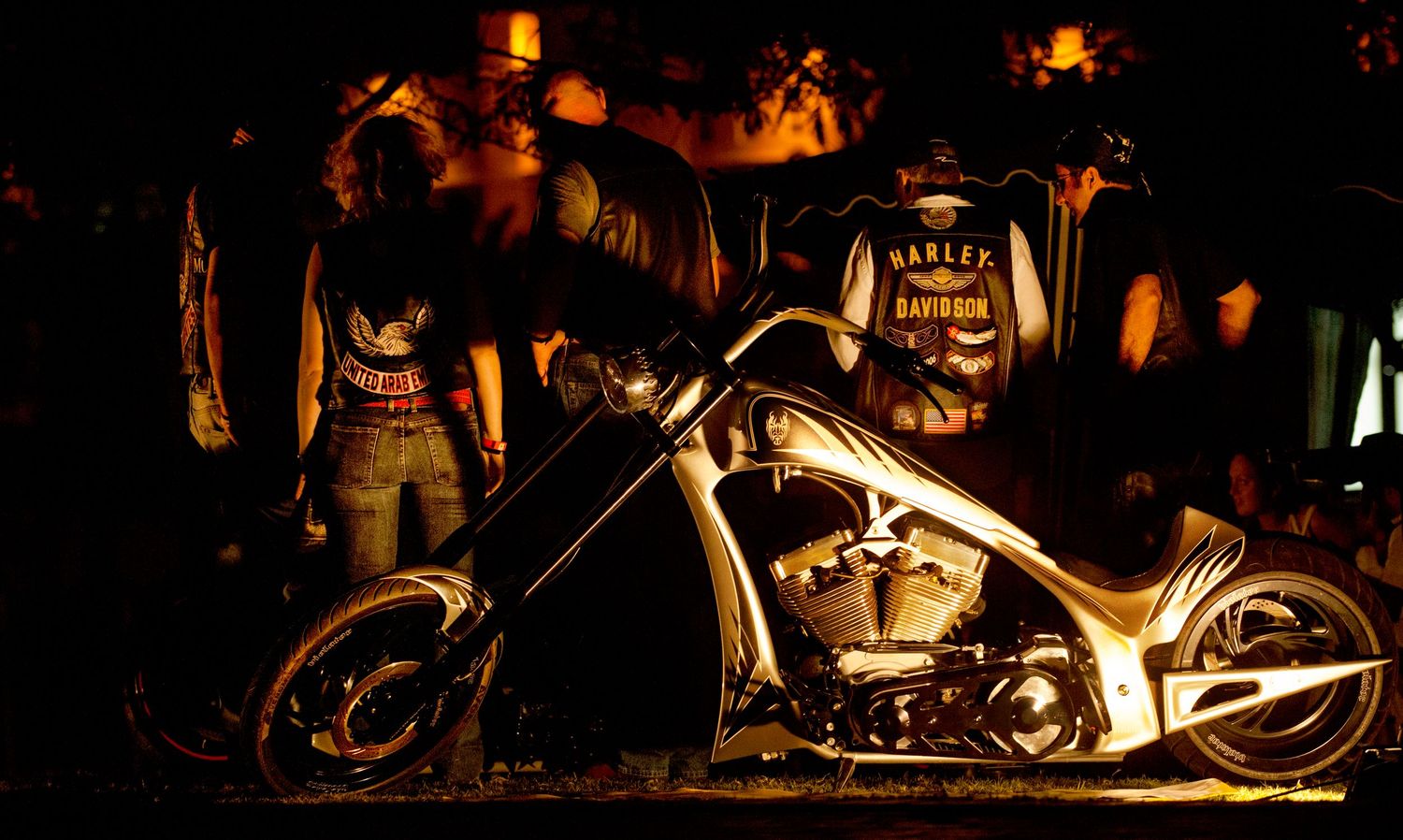 Motorcycles illuminated by warm lighting at night creating dramatic silhouettes. Commercial Photographer in Guelph and surrounding areas