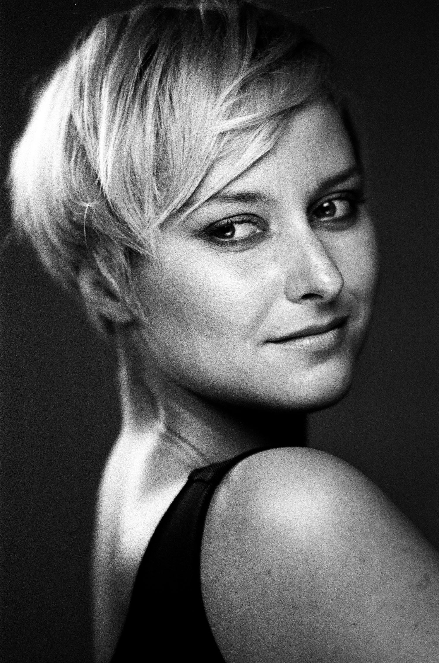 Artistic black and white headshots featuring short blonde hair and expressive poses. Portrait Photographer in Ontario