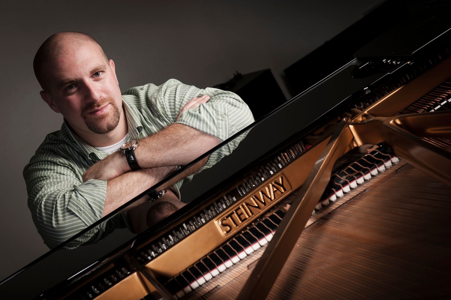 Artistic black and white photo of person at grand piano. Commercial Photographer in Guelph Ontario