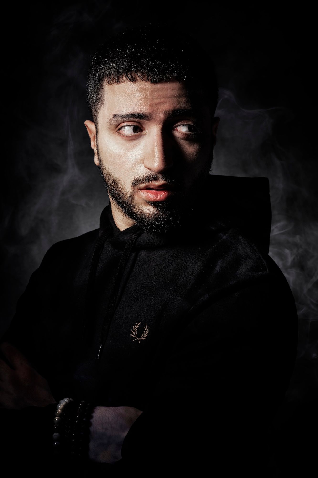 Dramatic portrait series in dark lighting showing close-up facial features against black background. portrait photographer in guelph and sur