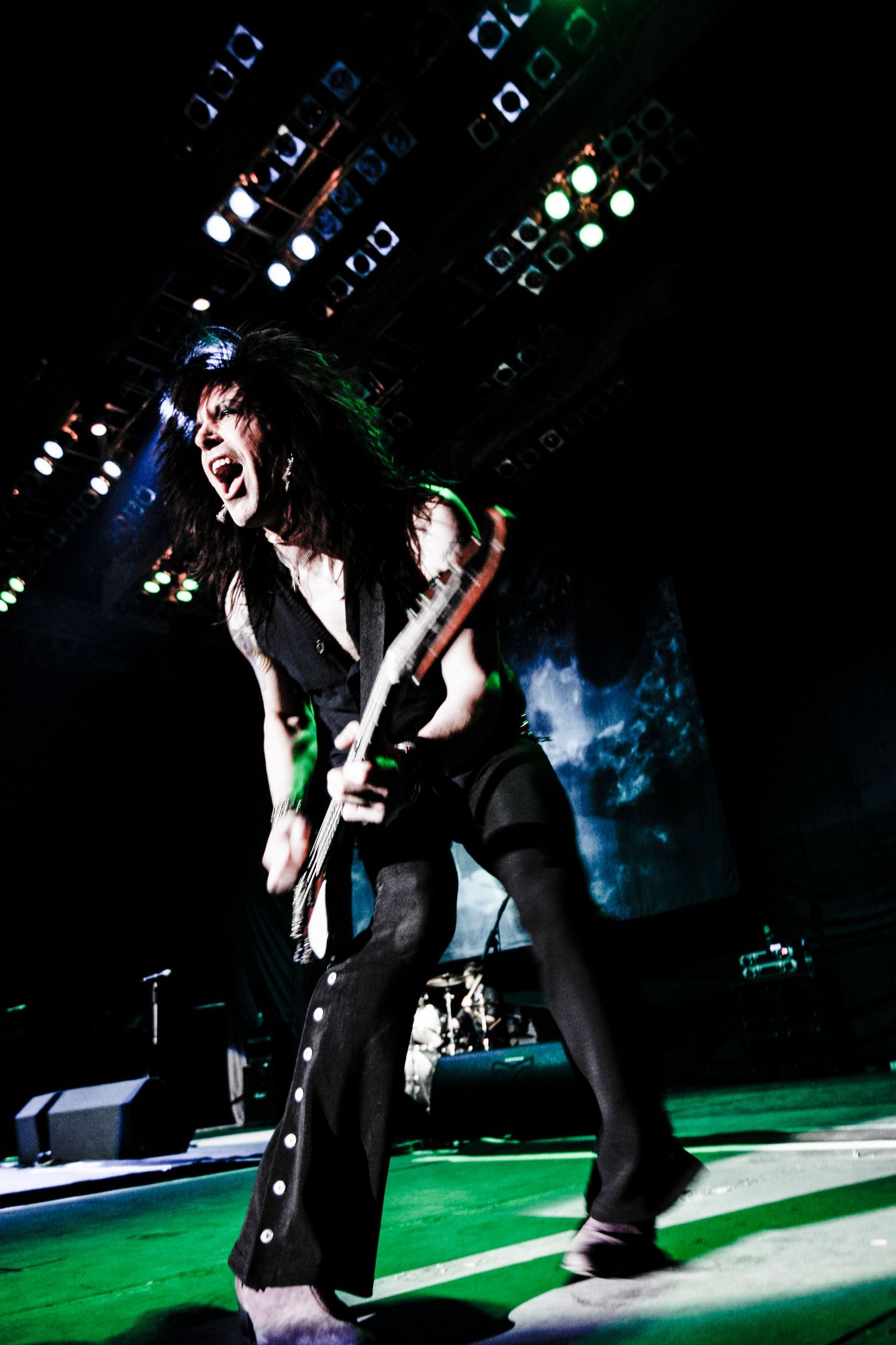 Rock band performing on stage with green lighting and dramatic concert atmosphere.event photographer in guelph ontario