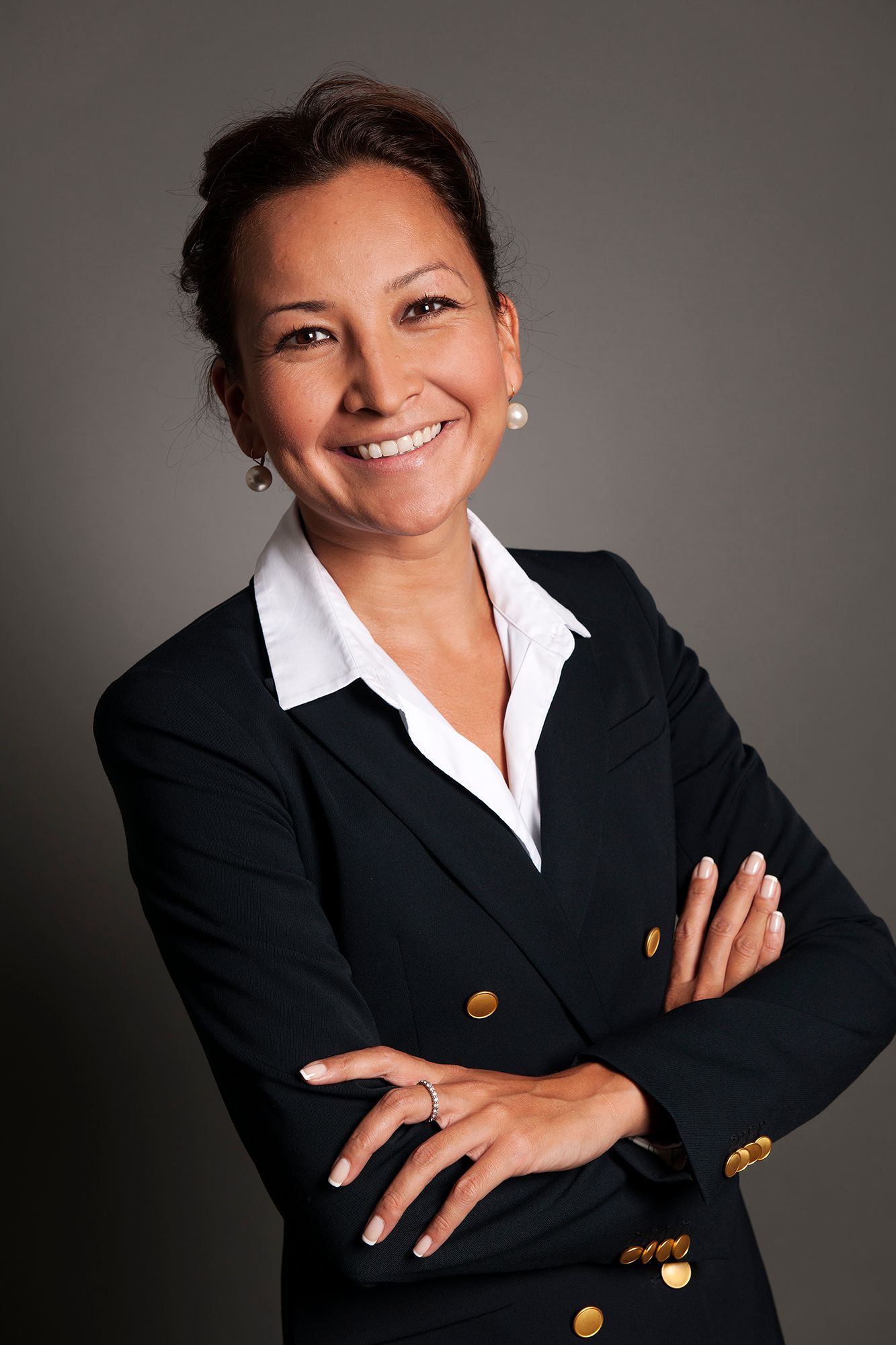 Professional headshot series of person in business attire against gray background. Commercial Photographer in Guelph and surrounding areas