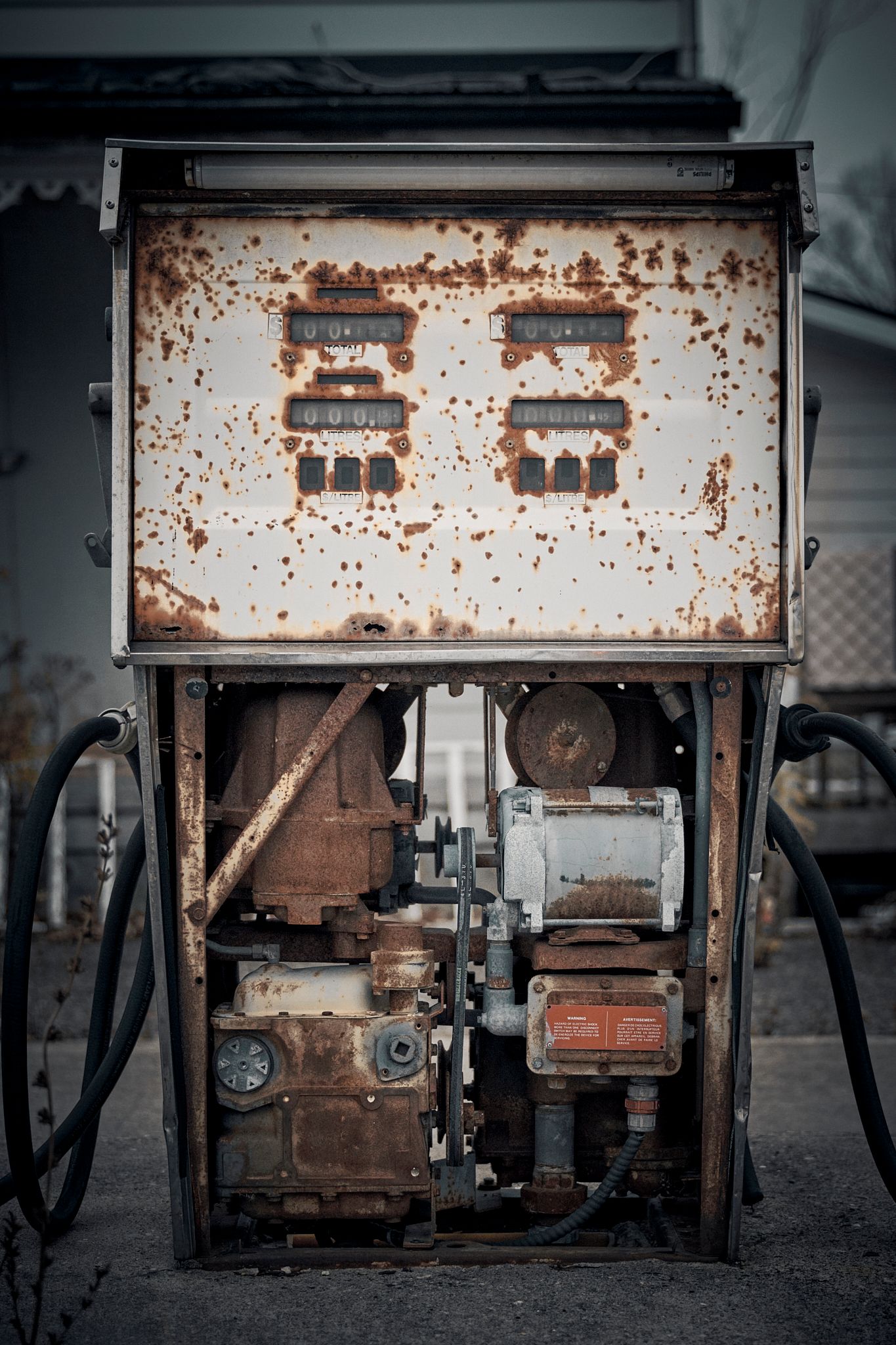 Weathered vintage gas pump showing severe rust and deterioration. Commercial Photographer in Guelph and surrounding areas