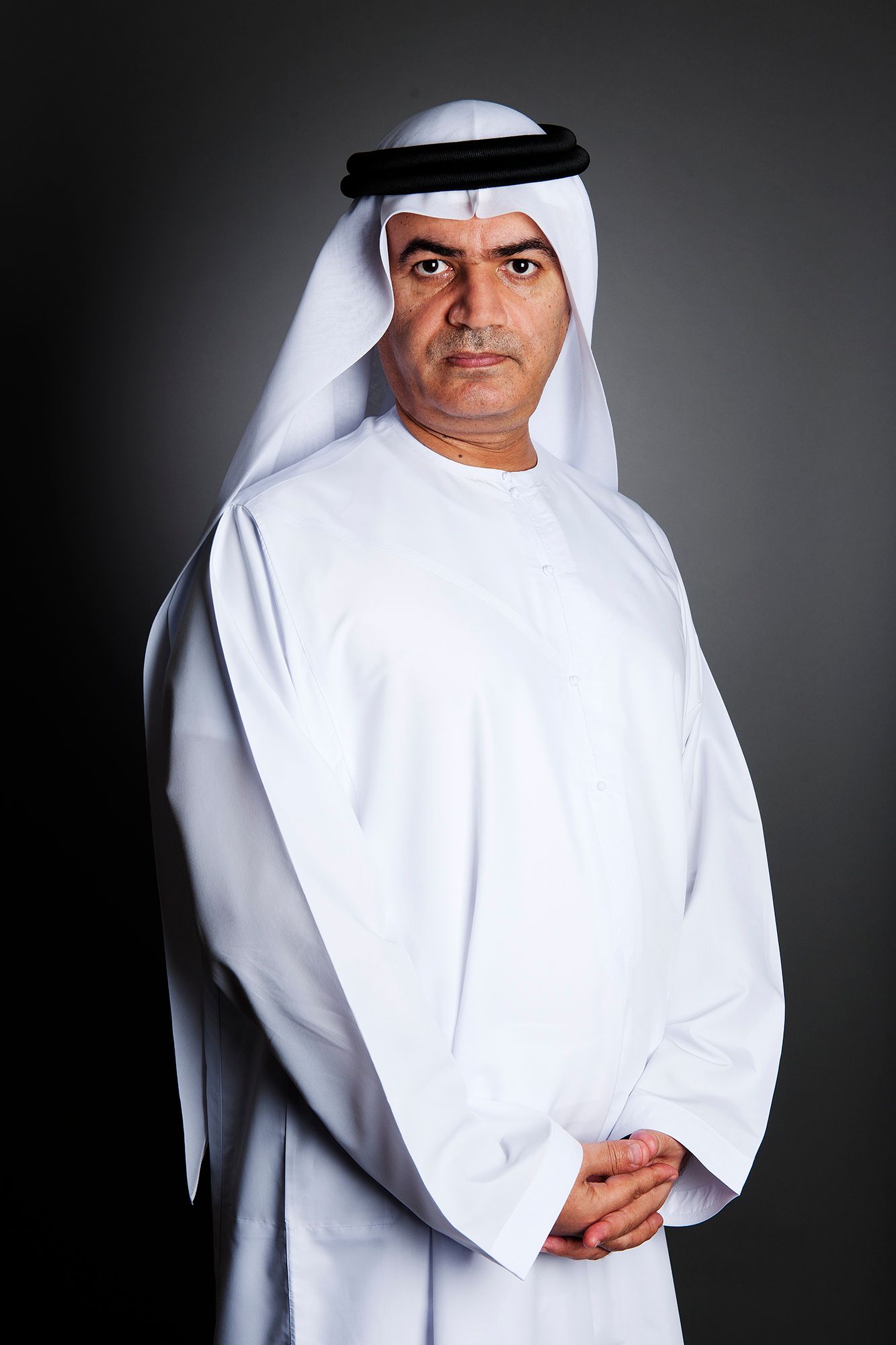 Person wearing traditional white Middle Eastern dress against dark background. Commercial Photographer in Guelph Ontario