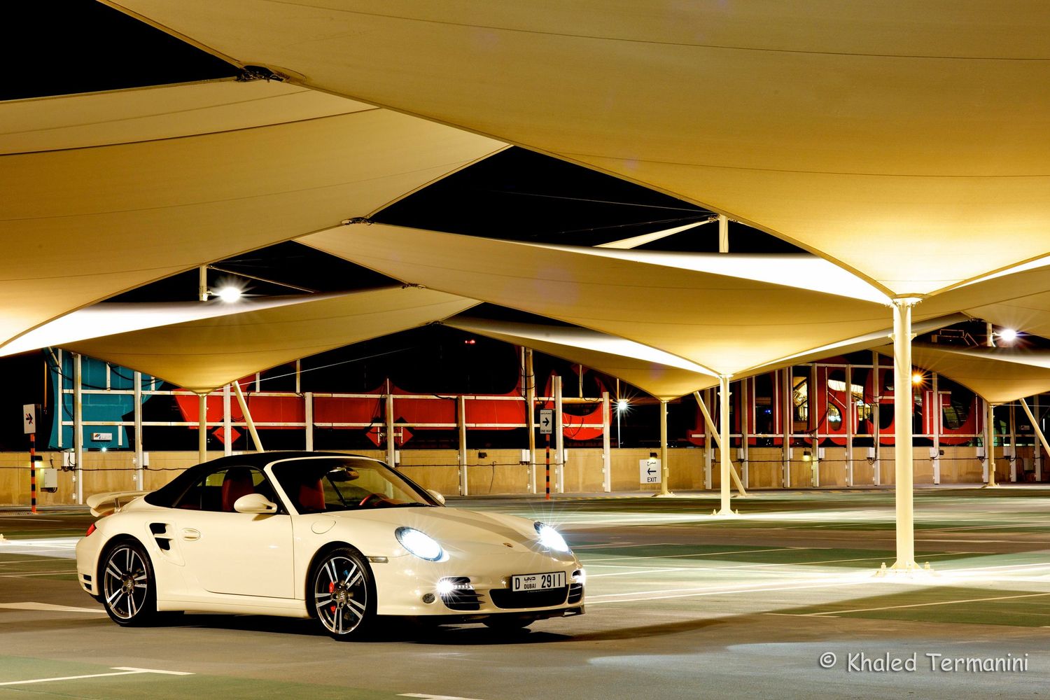Luxury cars parked in a modern underground parking garage with warm ambient lighting. car photography in ontario