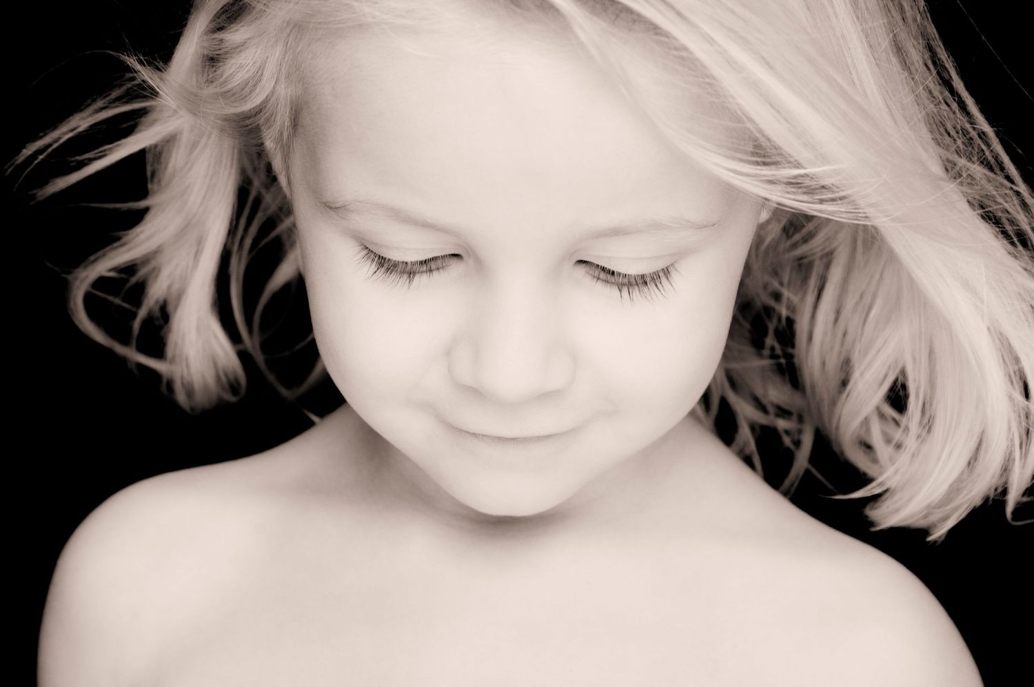 Soft black and white close-up portraits showing gentle expressions and blonde hair. Portrait Photographer in Ontario