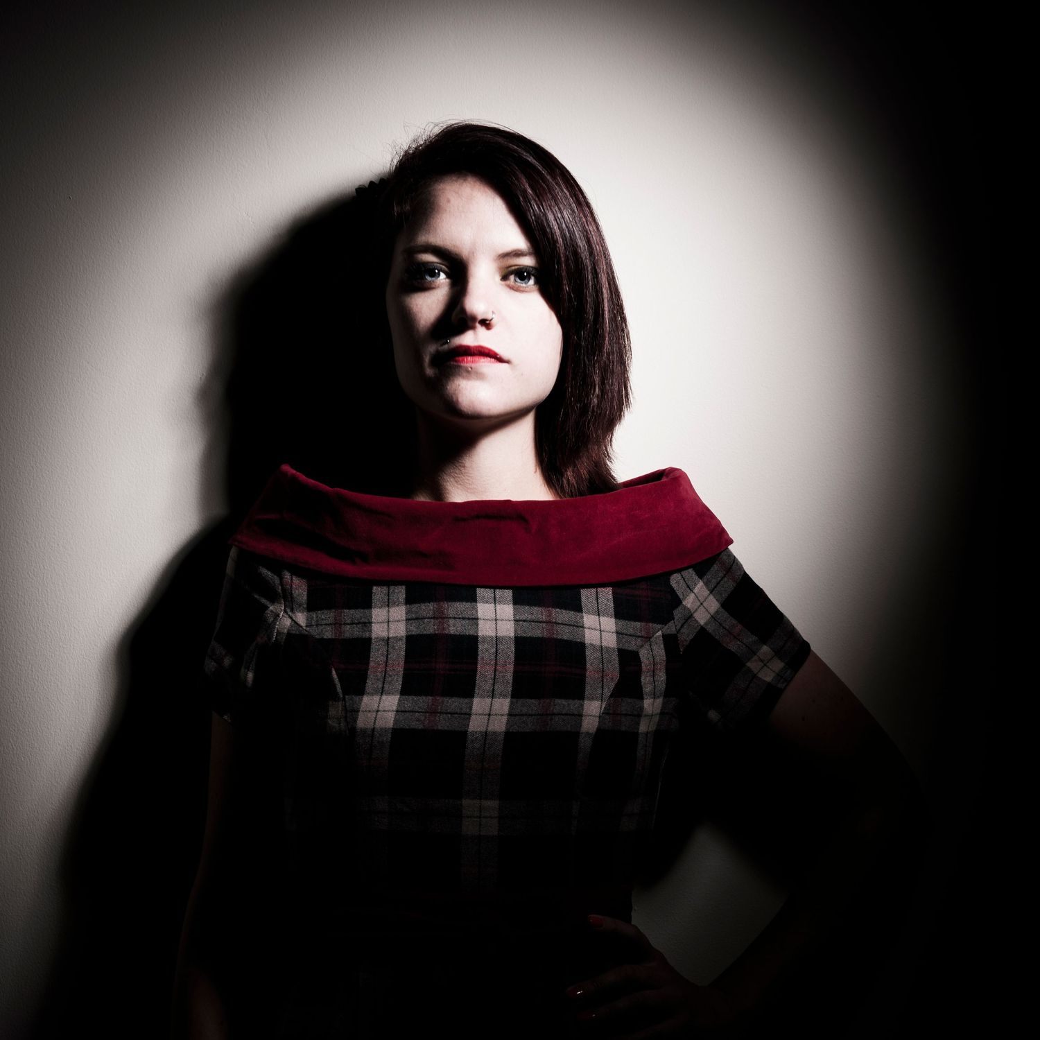 Moody portrait of person wearing plaid scarf in dramatic lighting. Portrait Photographer in Ontario