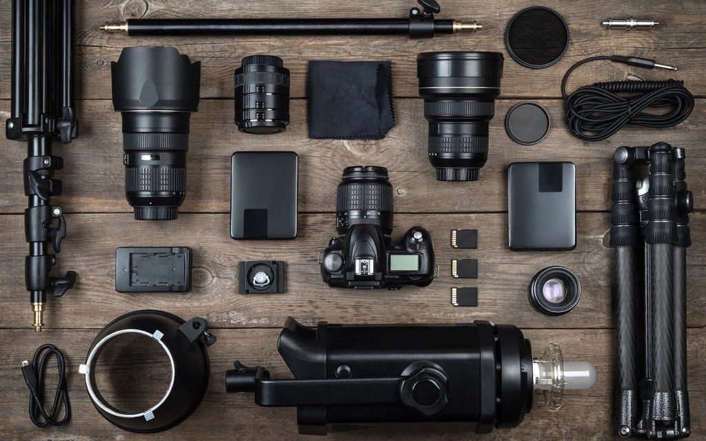 Overhead flat lay of professional photography equipment and lenses on wooden surface. Commercial Photographer in Guelph and surrounding area