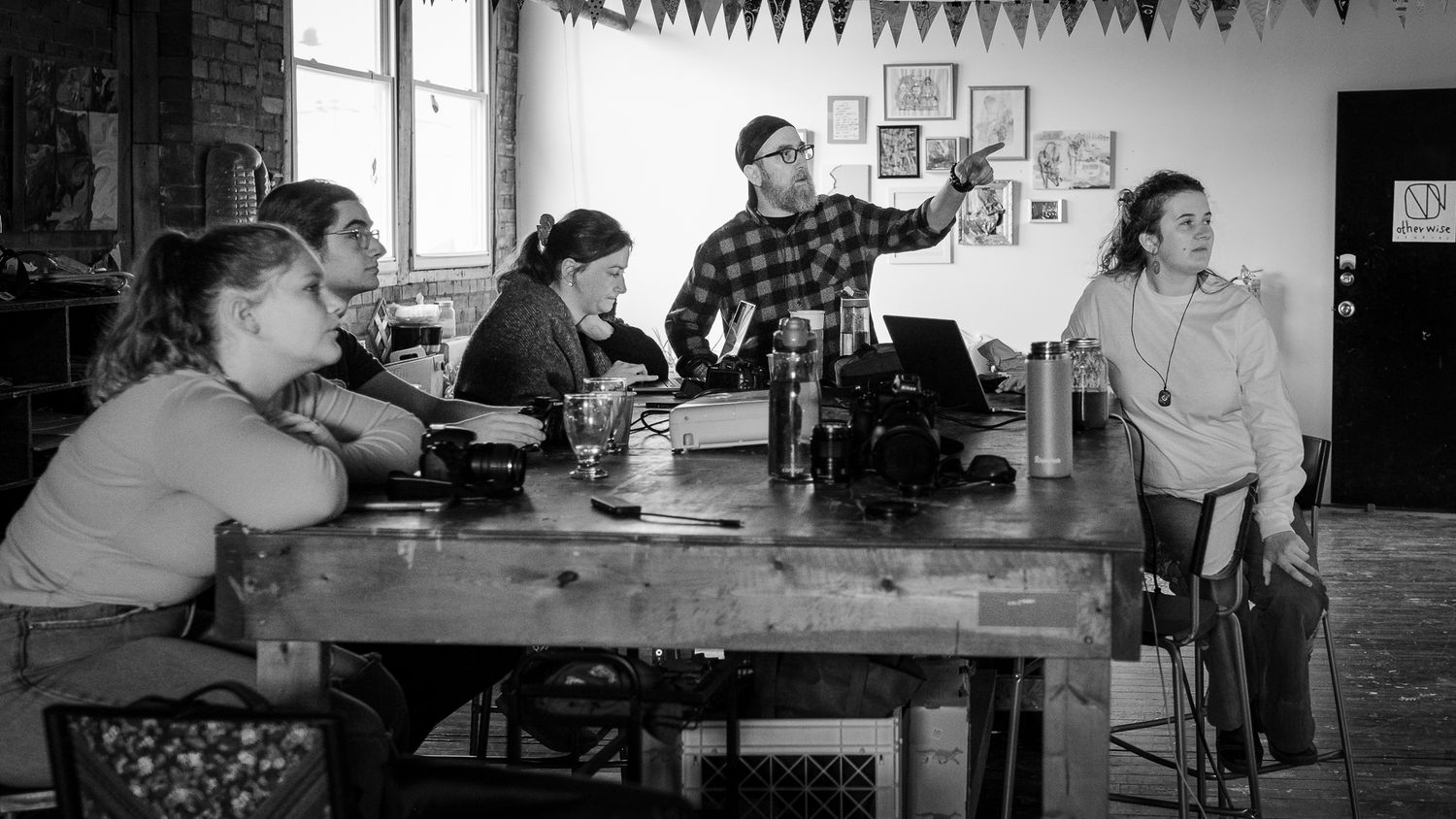 People gathered at tables in a community space with bunting decorations hanging above. photography workshops in guelph and surrounding areas