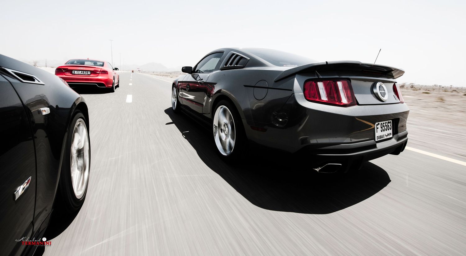 Classic Ford Mustangs and modern sports cars photographed in dynamic driving shots. car photography in ontario