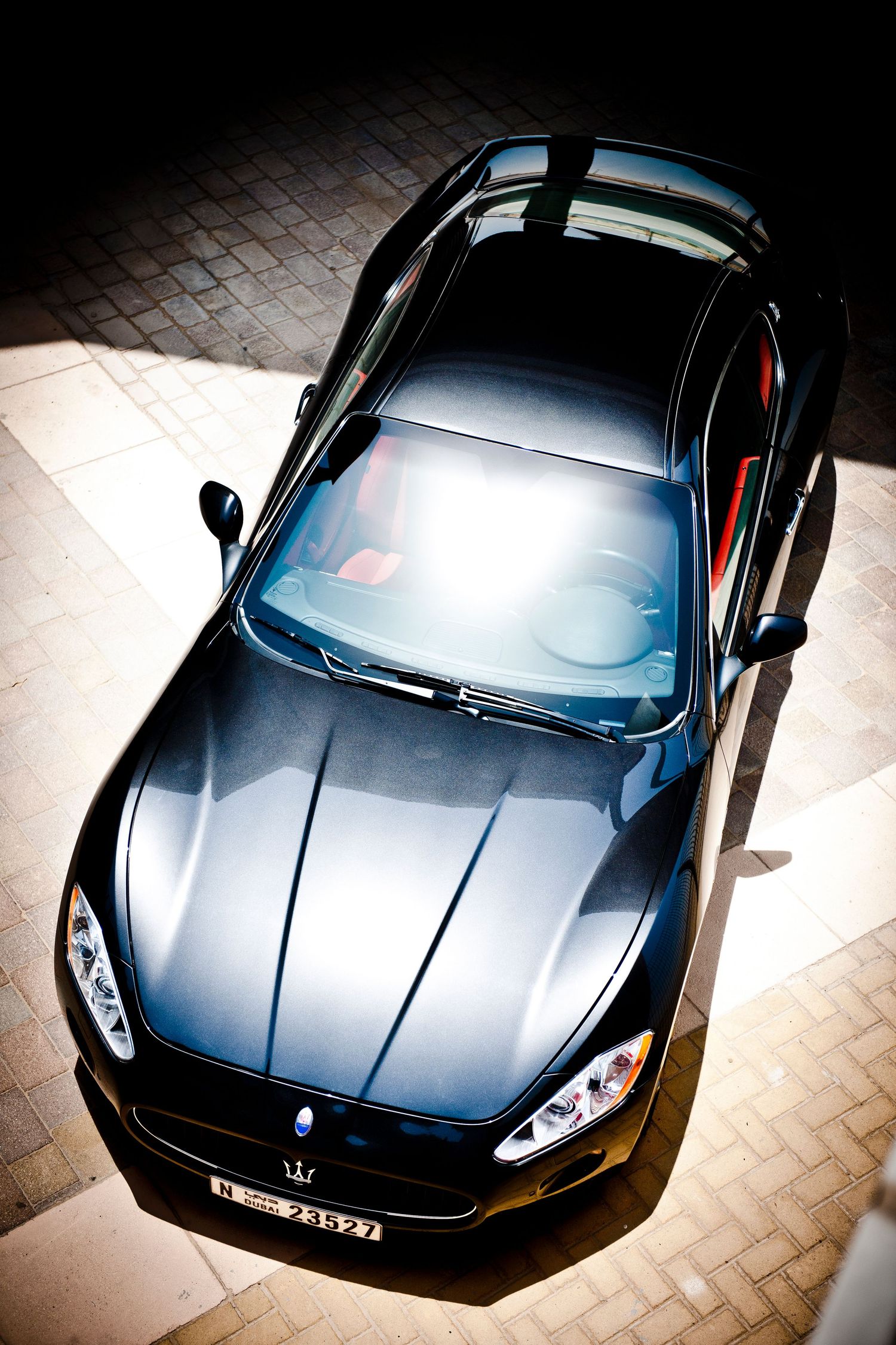 Sleek black sports car photographed from multiple dramatic angles in an urban setting. car photography in ontario