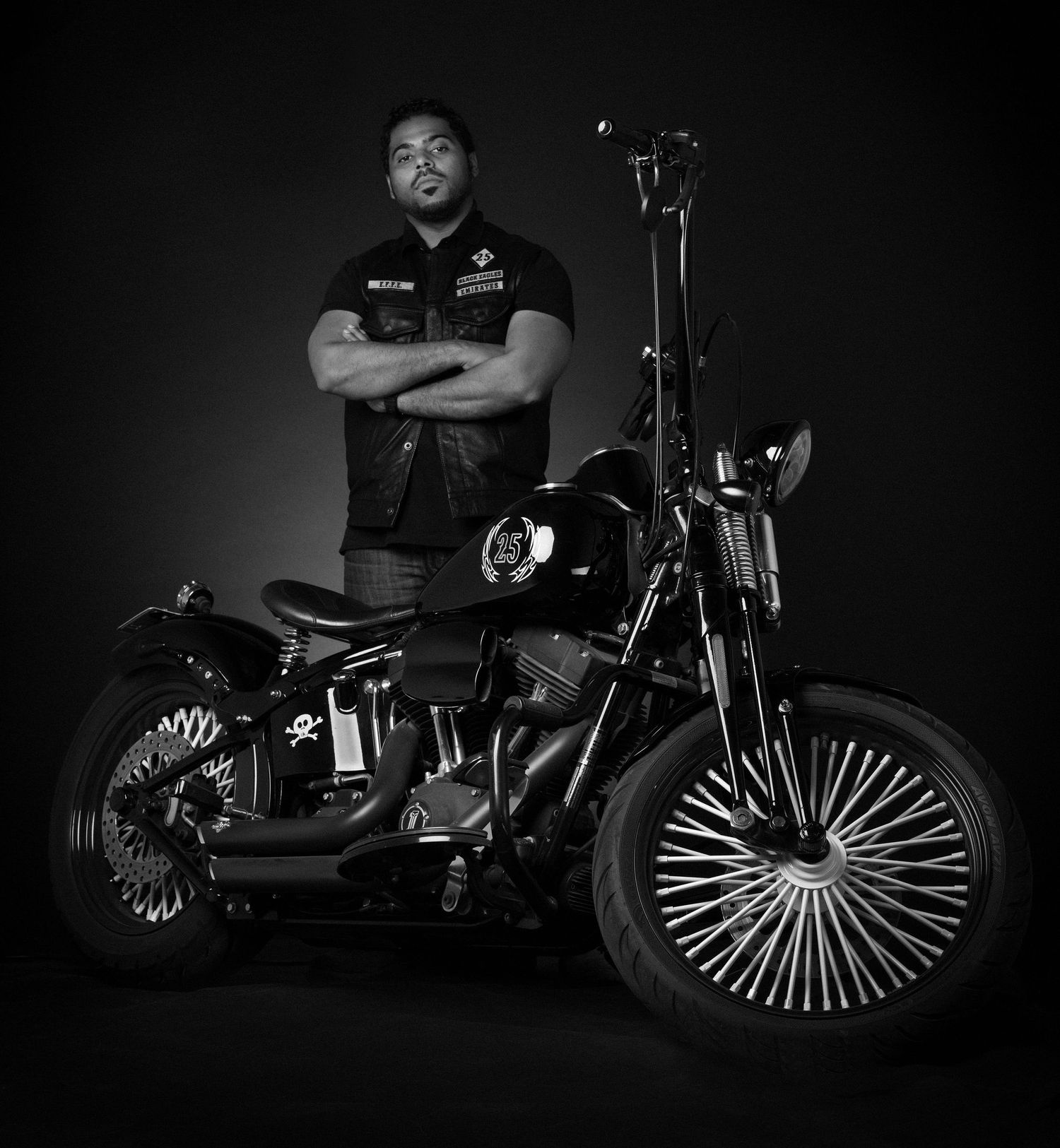 Custom motorcycles with large spoke wheels photographed in dramatic low-key lighting. Portrait Photographer in Ontario