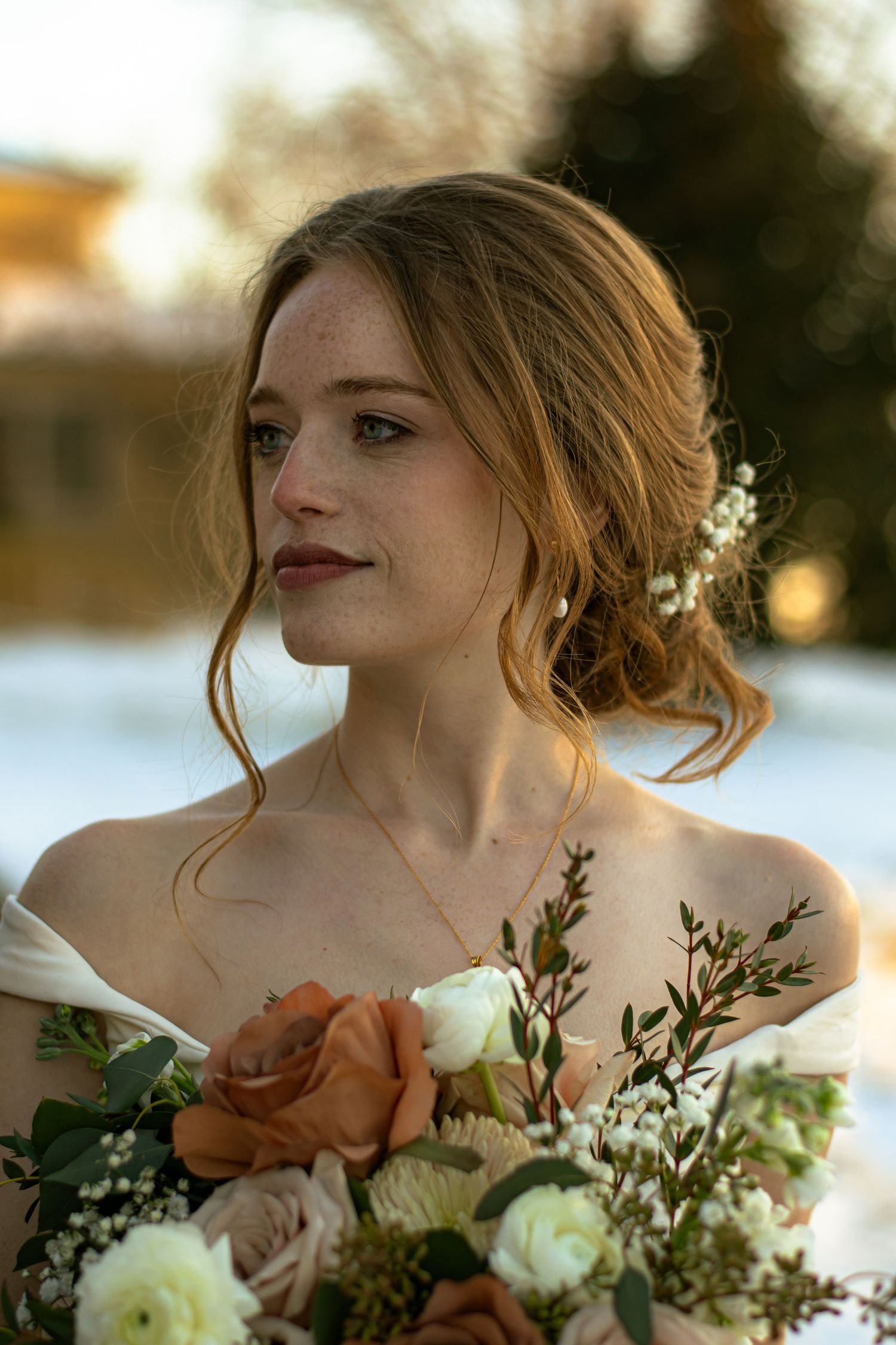 Bride standing posing for a bridal portrait on a beautiful plantation, surrounded by snow.
