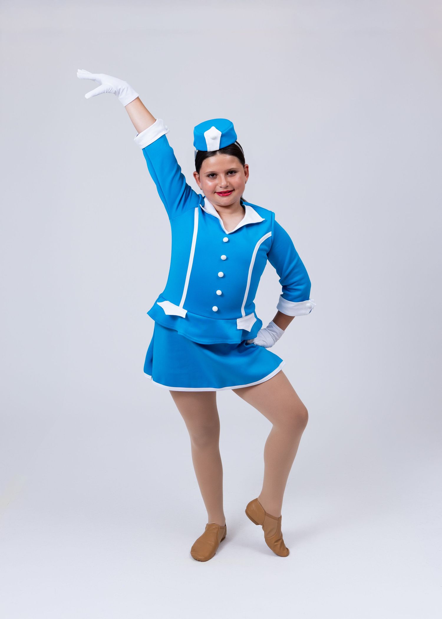Child dancer in blue and white majorette costume with hat and gloves strikes a pose.
