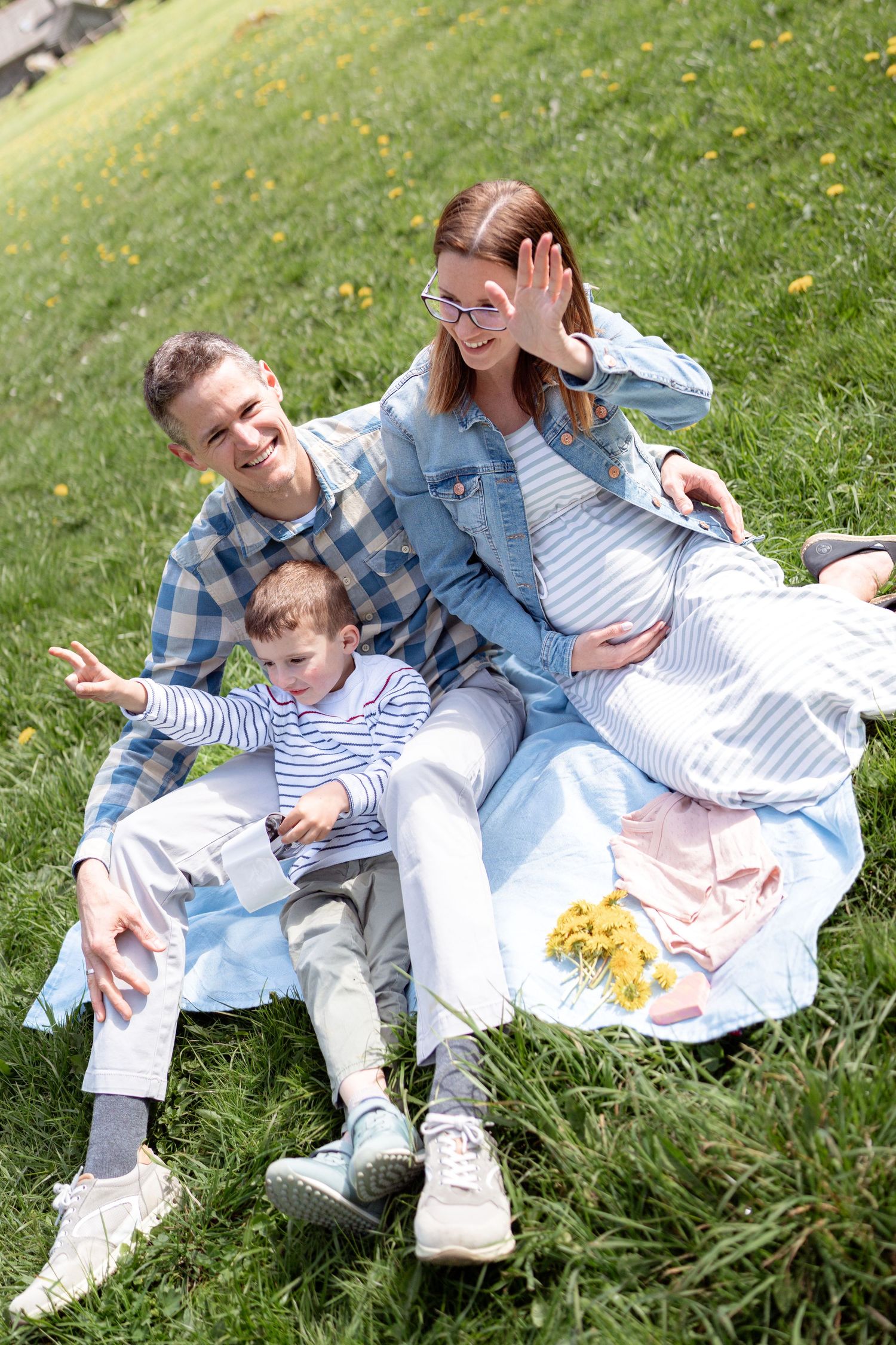 Casual outdoor family moments captured in blooming mountain meadow.