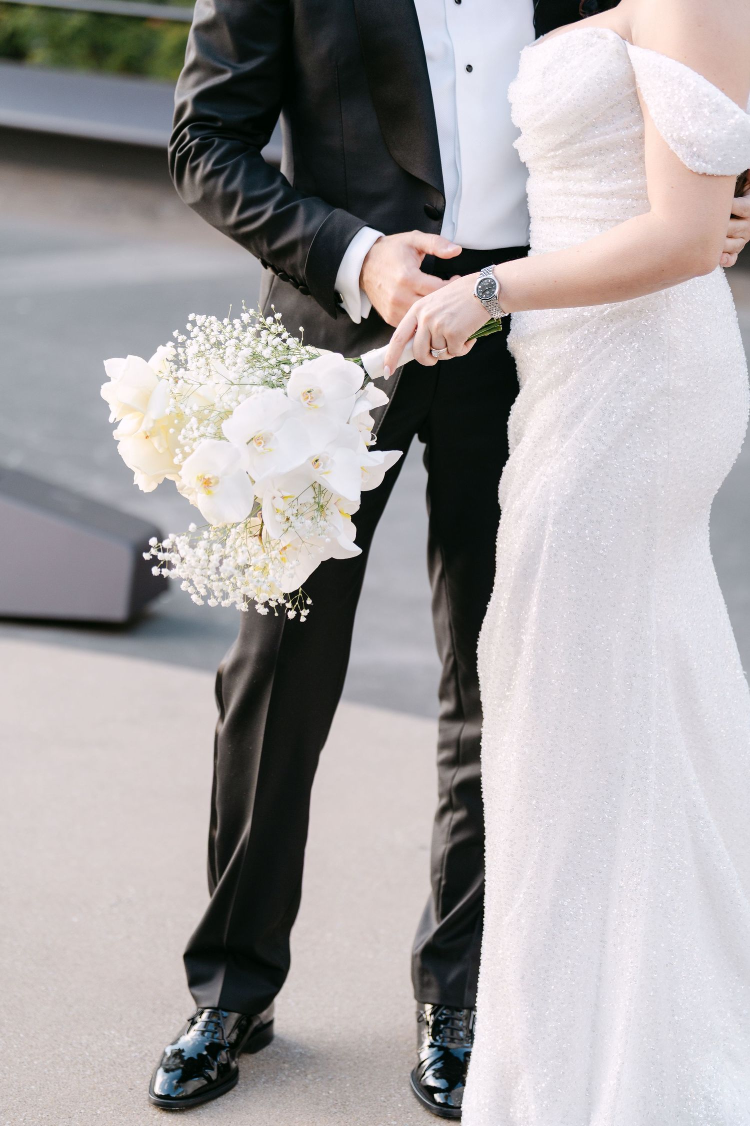 Detail shots of formal wedding attire and white floral bouquet against dark background.