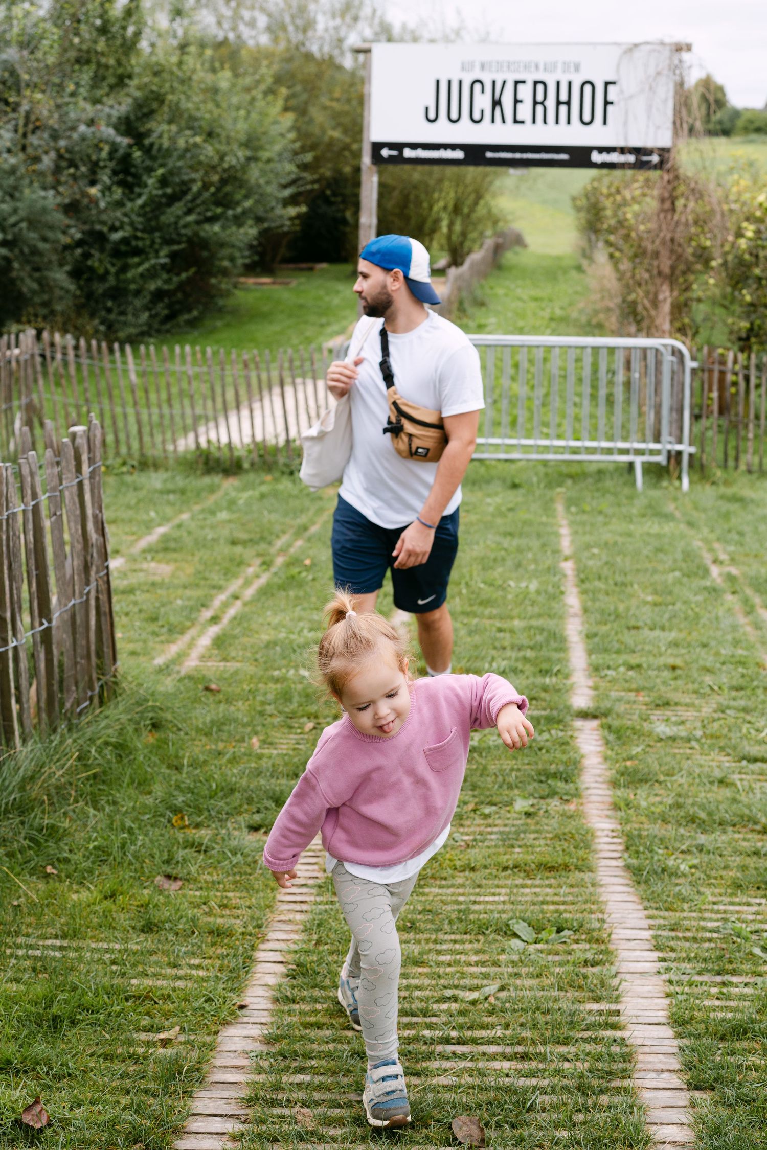 Walking path at Juckerhof farm with family enjoying outdoor activities.