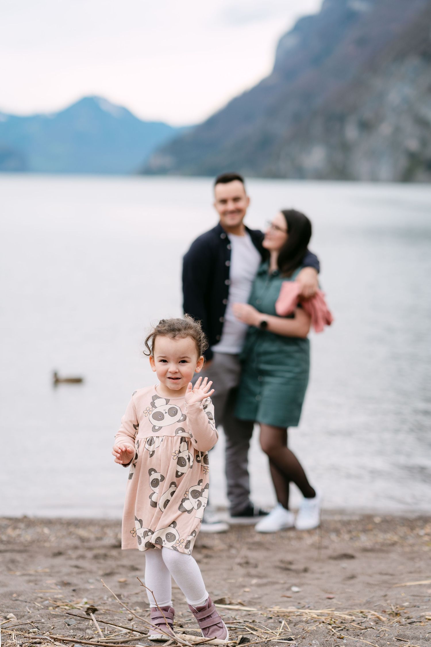 Family enjoying time together by a scenic mountain lake.
