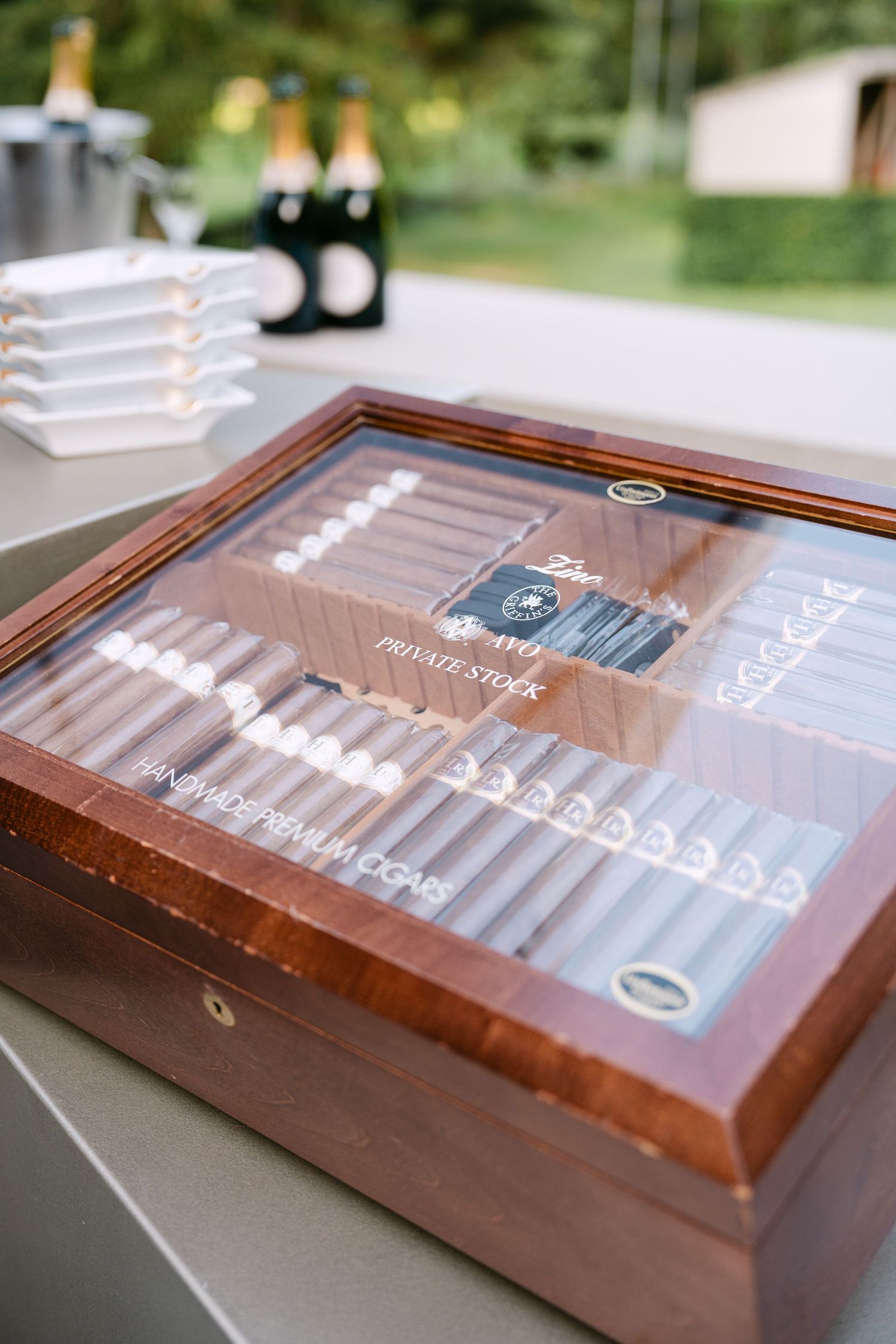 Wooden display case with cigar collection at luxury event setup.