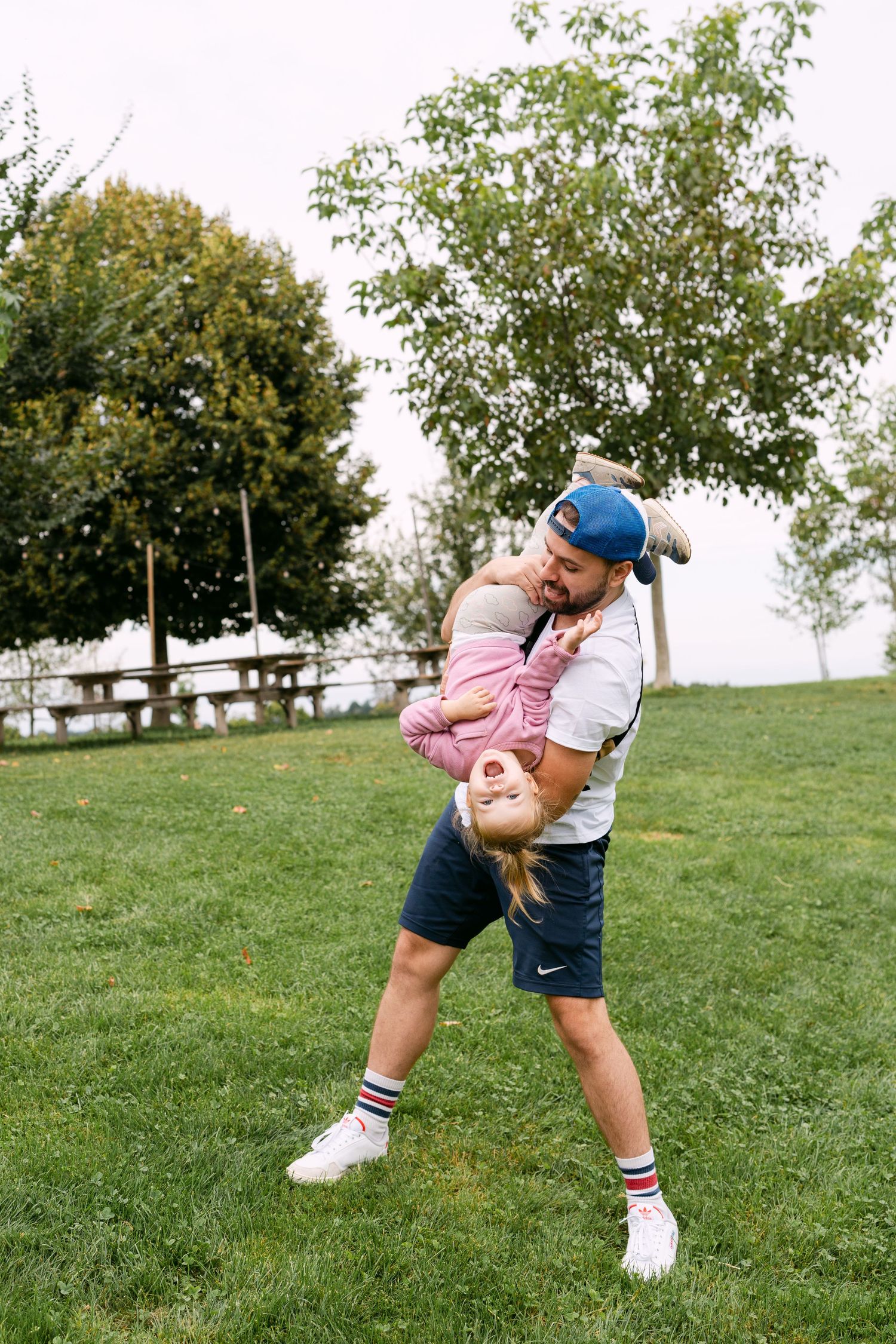 Playful outdoor scenes showing people being active and having fun on a grassy hillside.