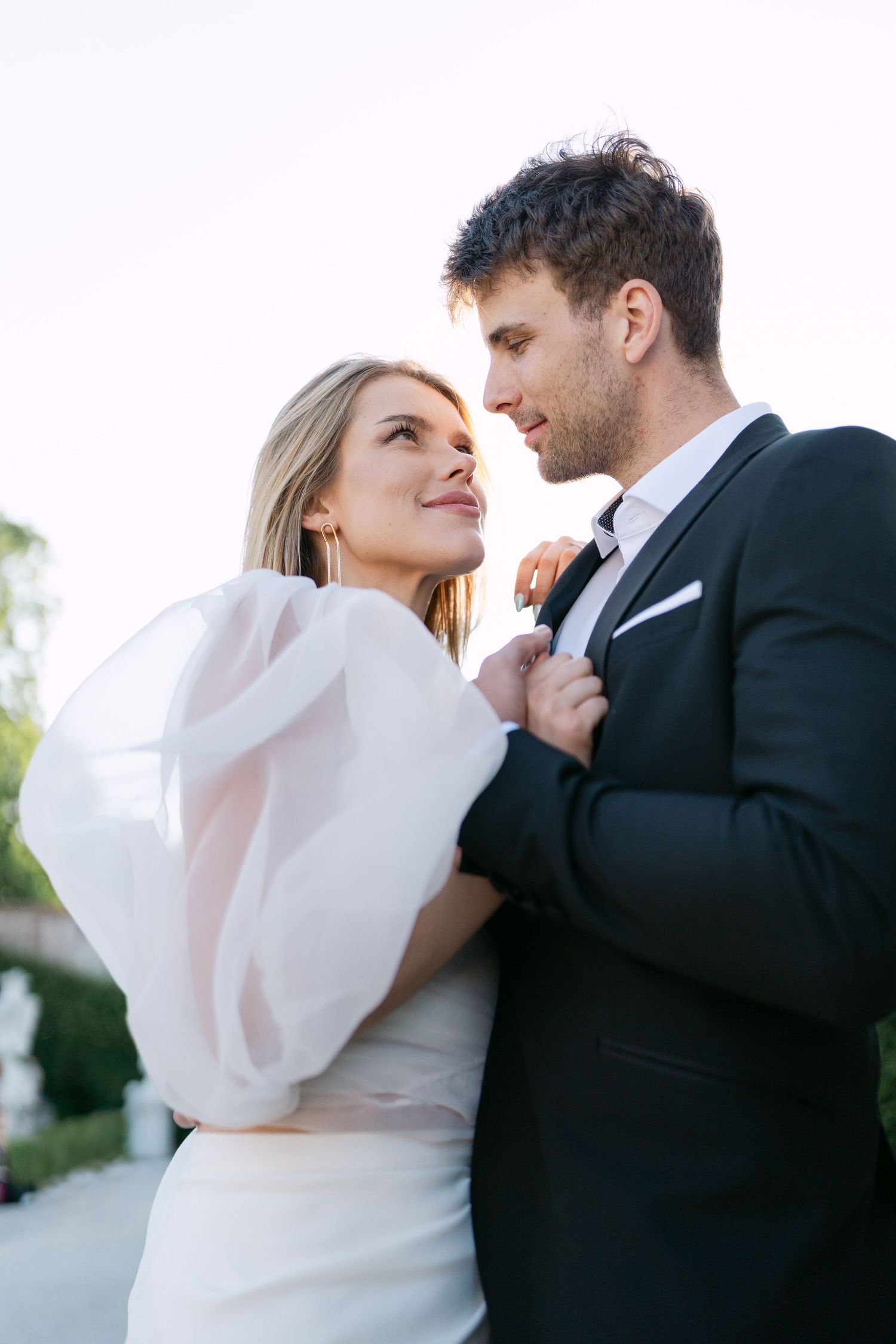 Intimate portrait of a couple in formal attire sharing a tender moment.