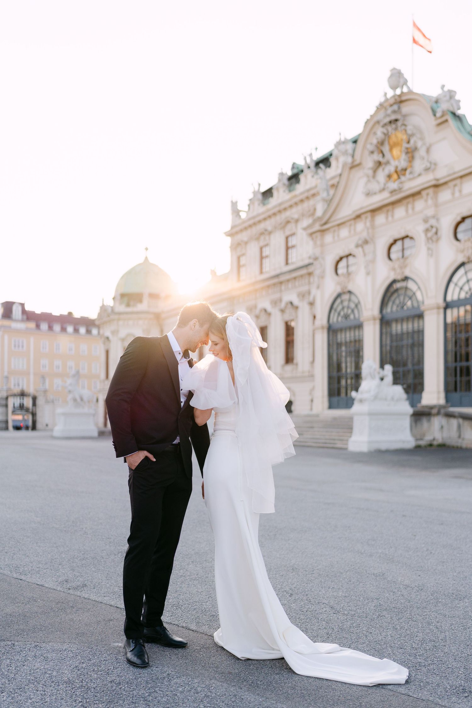 Romantic sunset wedding portrait at the Belvedere Palace with beautiful architectural backdrop.