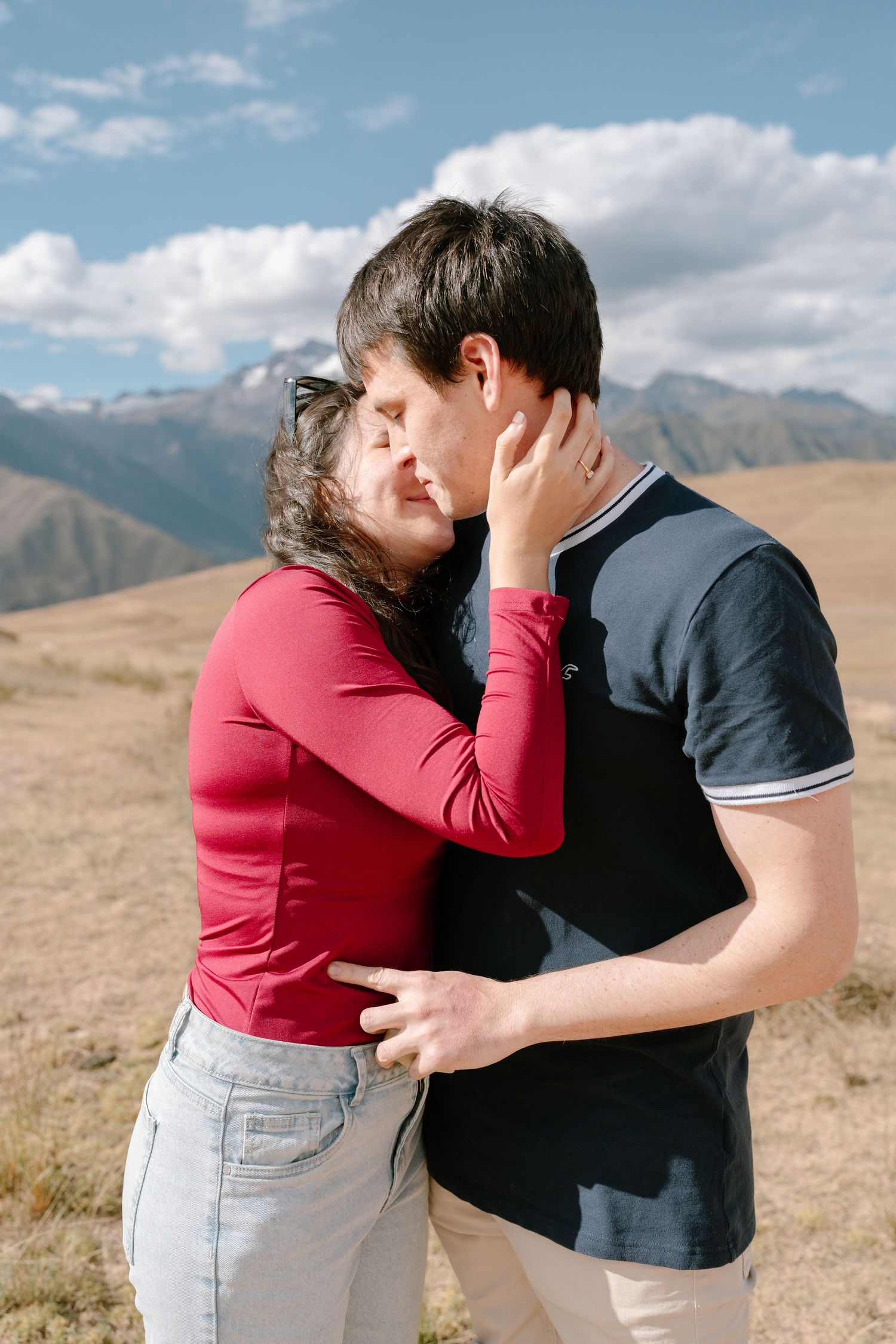Intimate couple portraits captured in a desert landscape with mountains in the background.