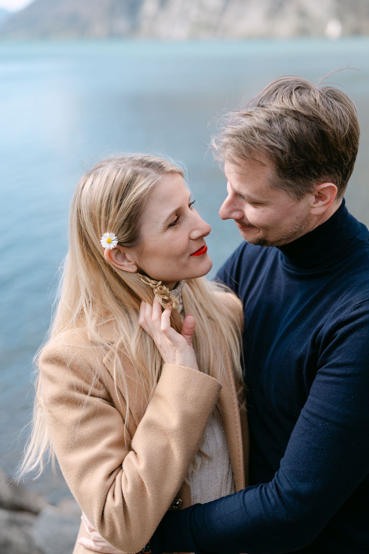 Romantic sequence showing tender moments between couple by scenic lake.
