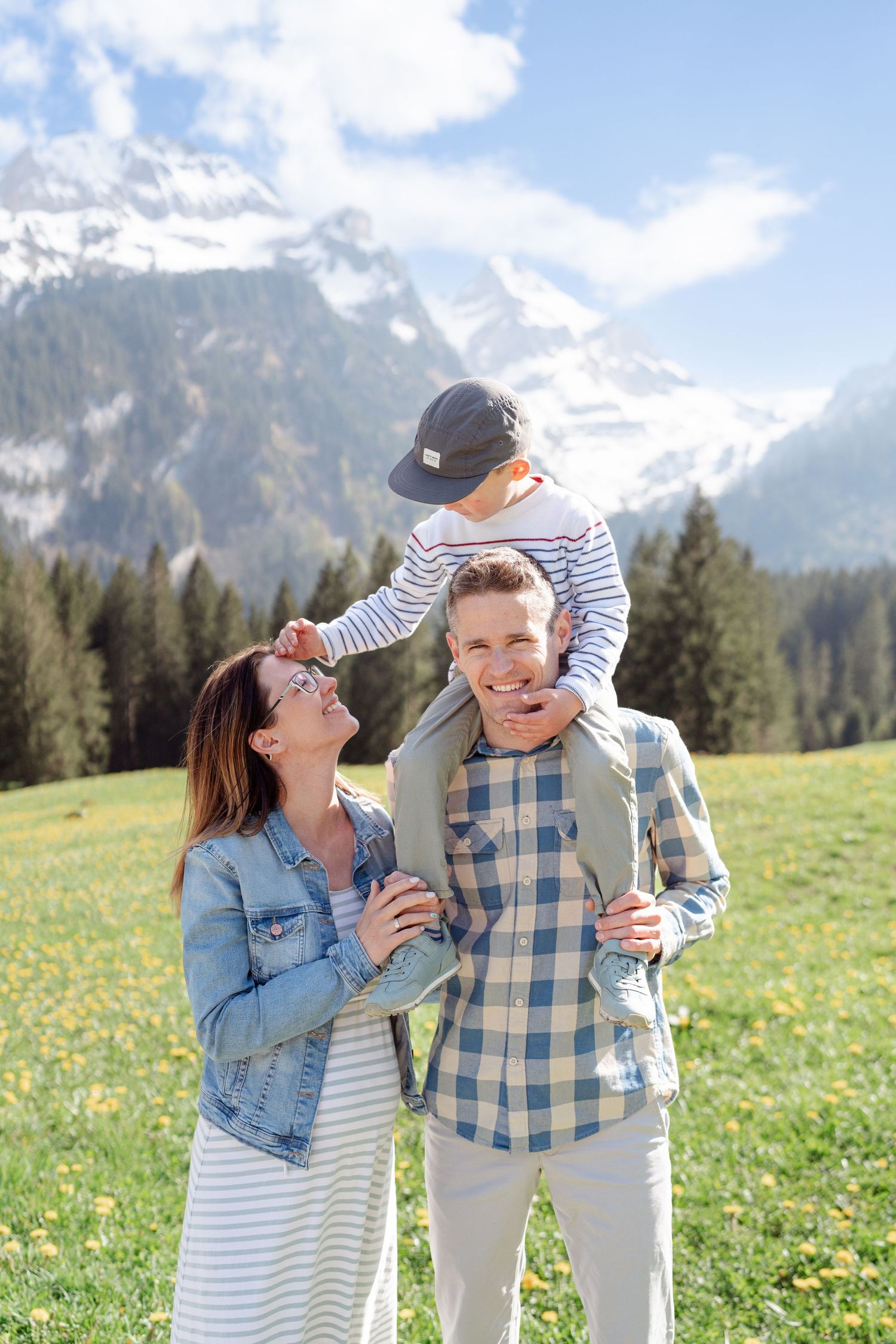 Candid moments in a mountain meadow with wildflowers and evergreen forest backdrop.