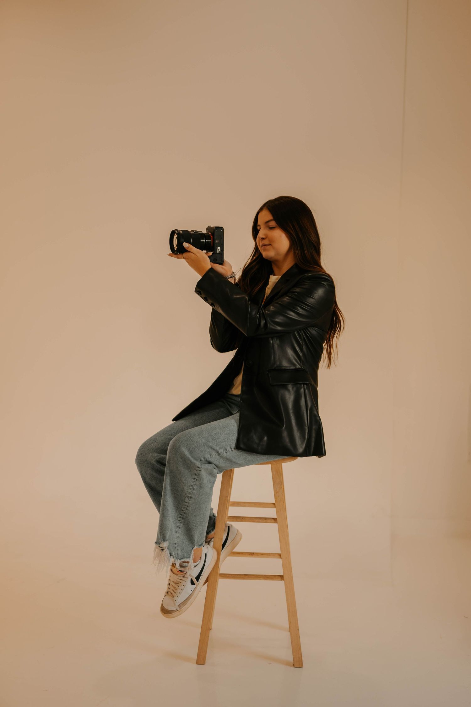 Creative portrait sequence of someone posing dramatically on a wooden stool in studio lighting.