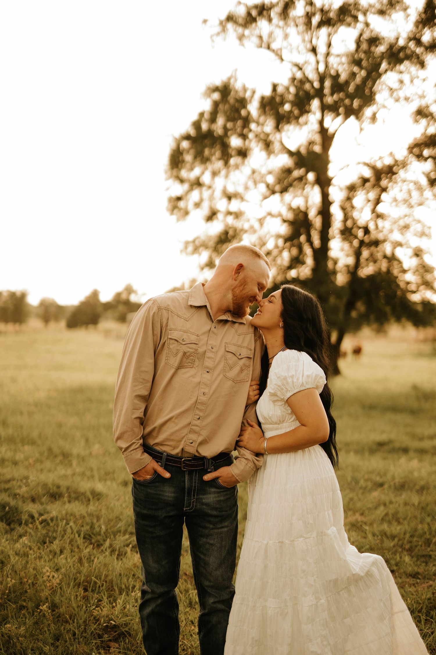 Candid outdoor family portrait session during golden sunset in rustic setting.