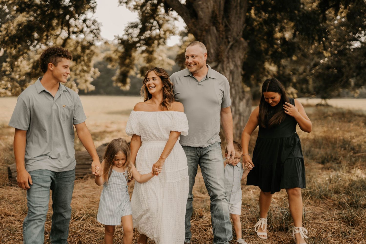 Group photo session captured in warm sunset light on rustic terrain.