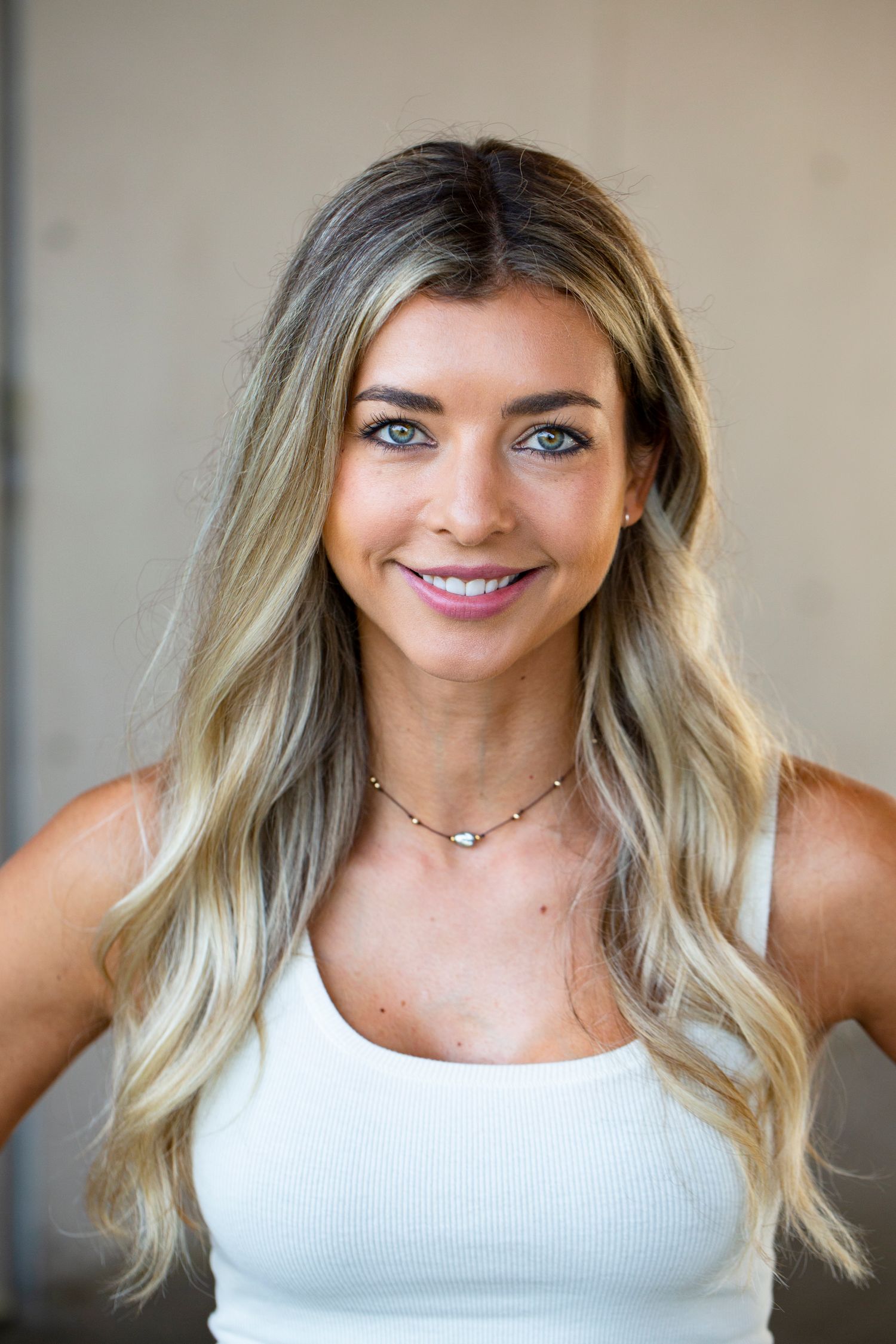Portrait series in white tank top showing different expressions.