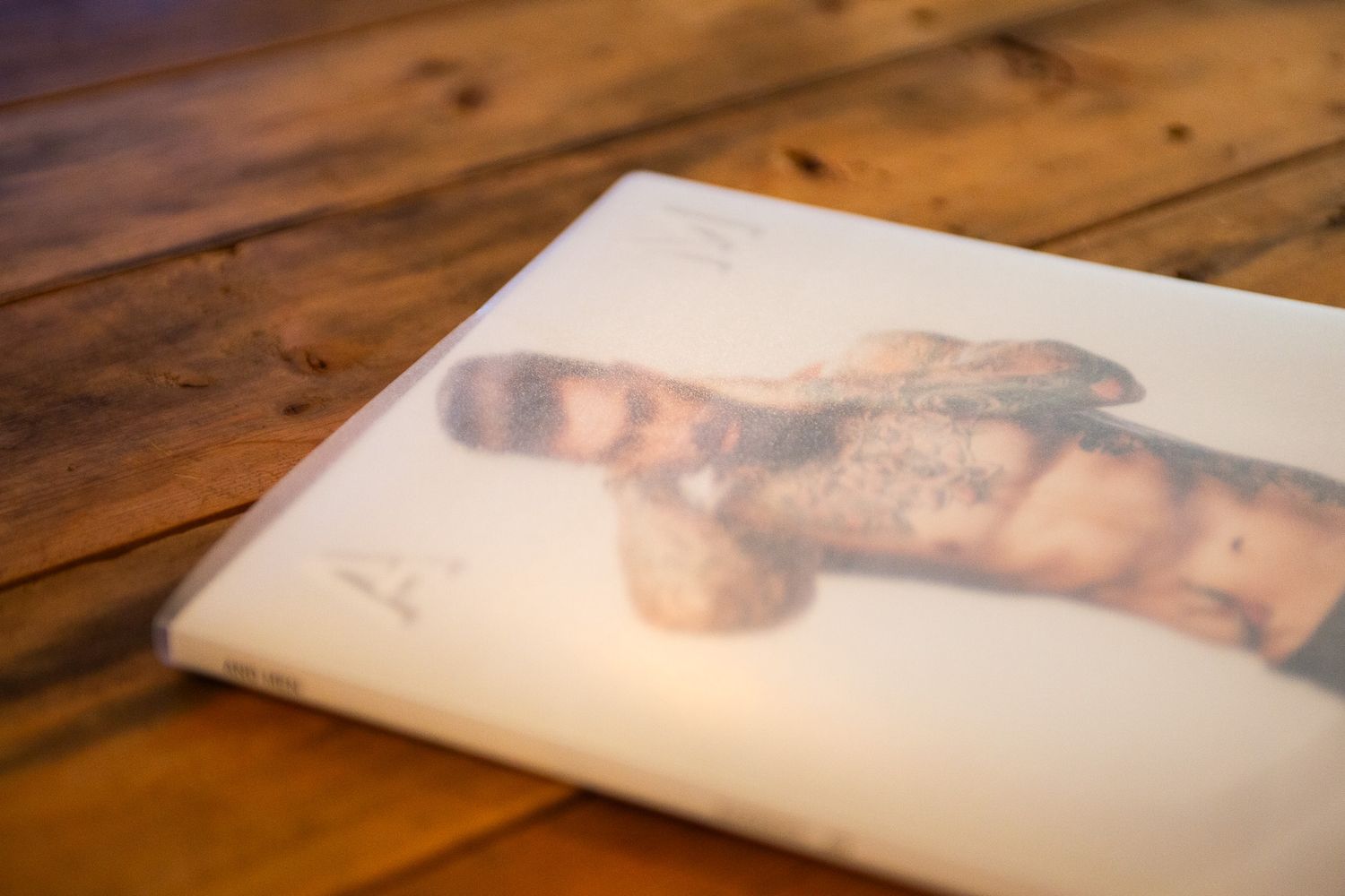 Faded vintage photograph on a rustic wooden table surface.